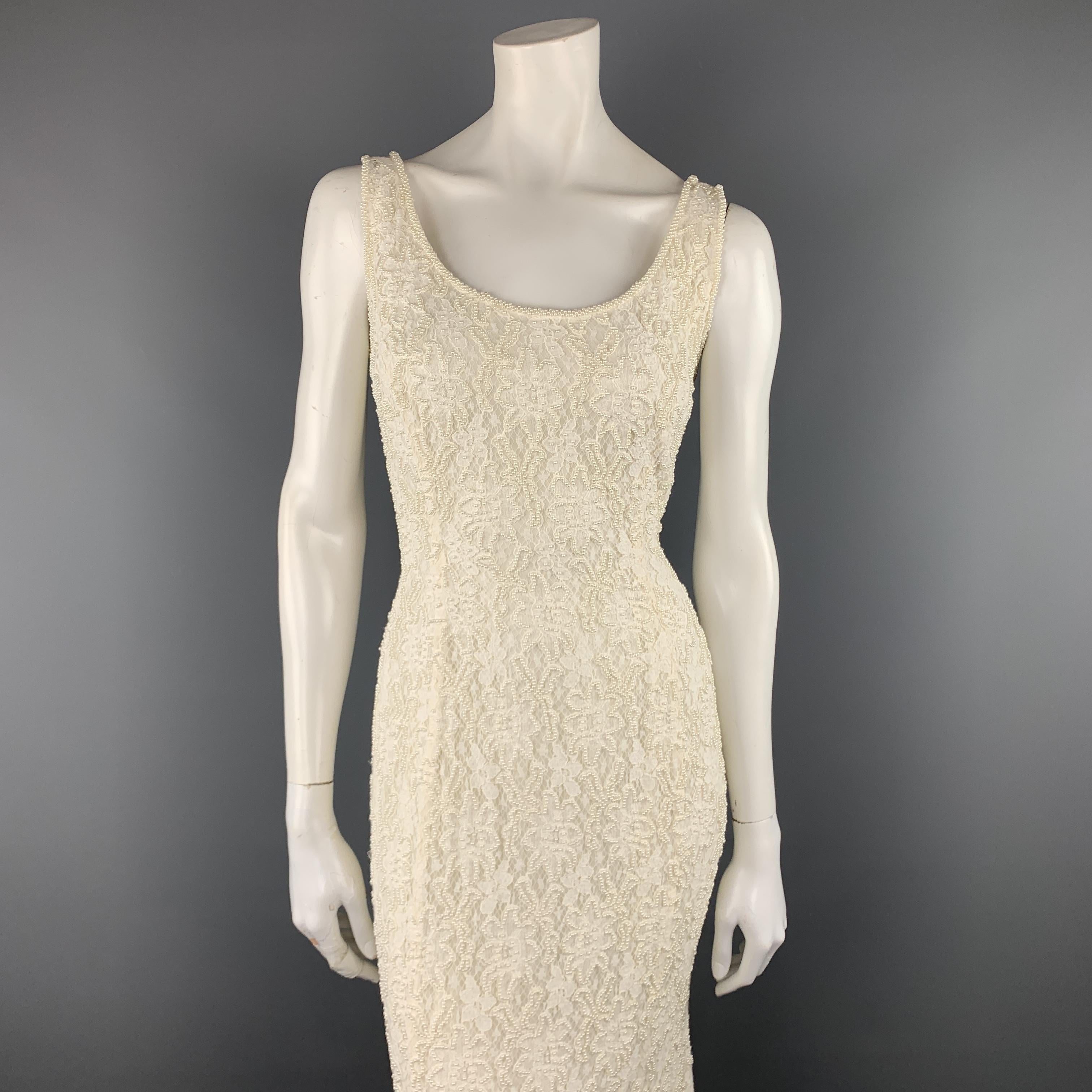 CARMEN MARC VALVO gown comes in cream viscose with a beaded lace overlay featuring a scoop neck and flared hem. 

Excellent Pre-Owned Condition.
Marked: 4

Measurements:

Shoulder: 14 in.
Bust: 36 in.
Waist: 28 in.
Hip: 40 in.
Length: 57 in.
