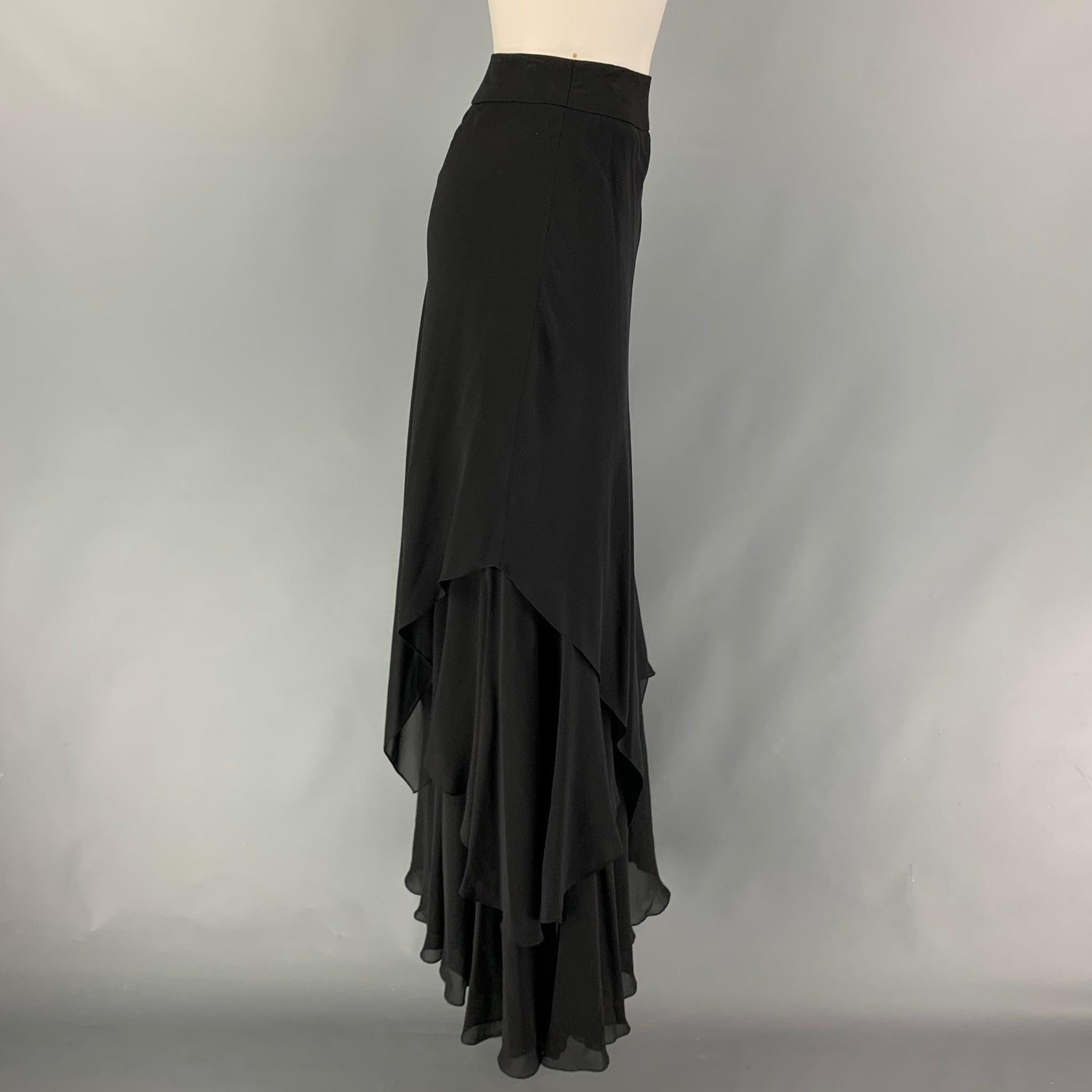 CARMEN MARC VALVO skirt comes in a black silk featuring an asymmetrical style, ruffled, and a side zip up closure.
 Very Good
 Pre-Owned Condition. 
 

 Marked:  8 
 

 Measurements: 
  Waist: 28 inches Hip: 33 inches Length: 47 inches 
  
  
  

