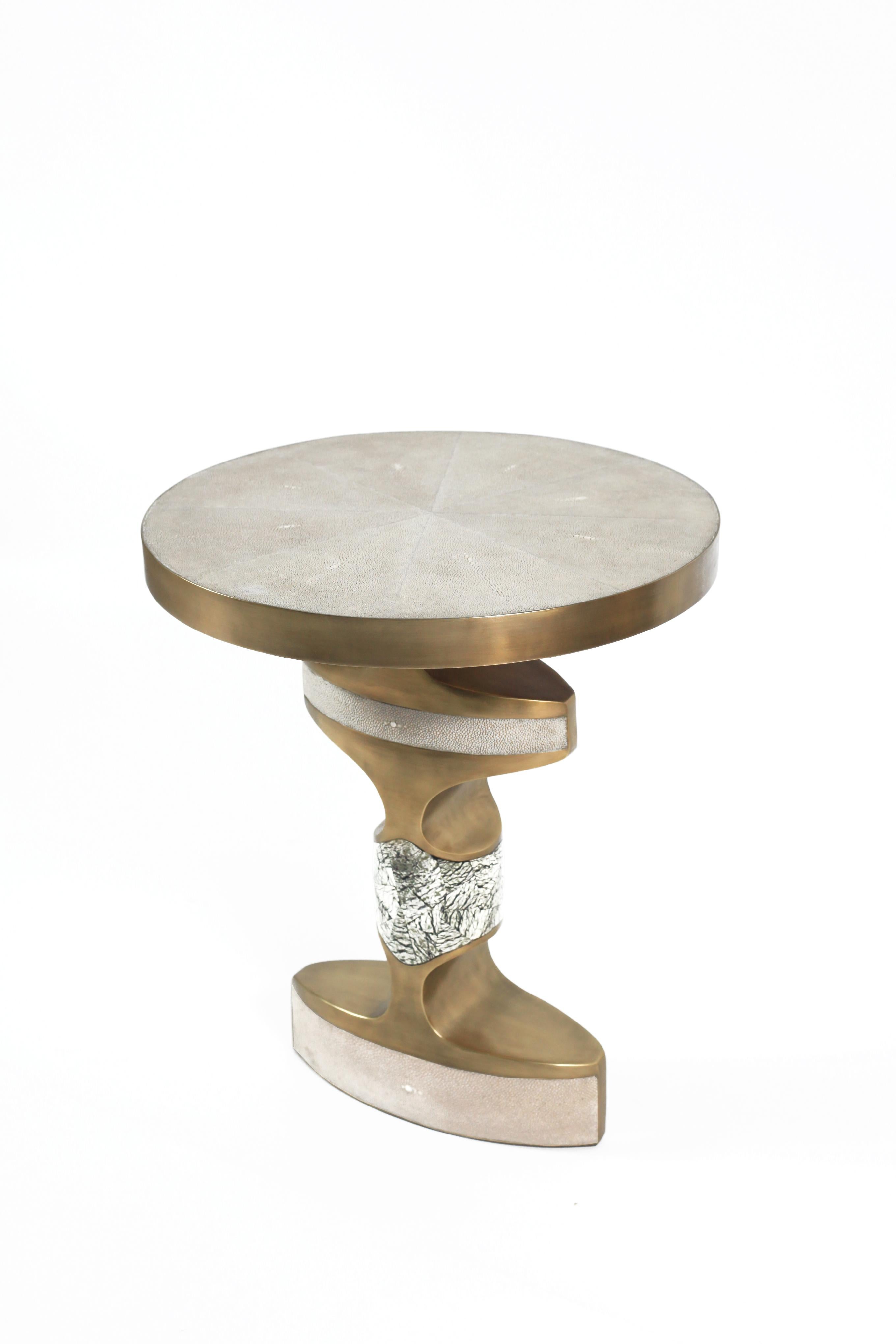 The Carmen Side Table is an elegant and sculptural piece that will light up your space with it’s exotic details. Inlaid in 3 different materials: cream shagreen, Baguio stone and finished with bronze-patina brass accents. Available in a mink