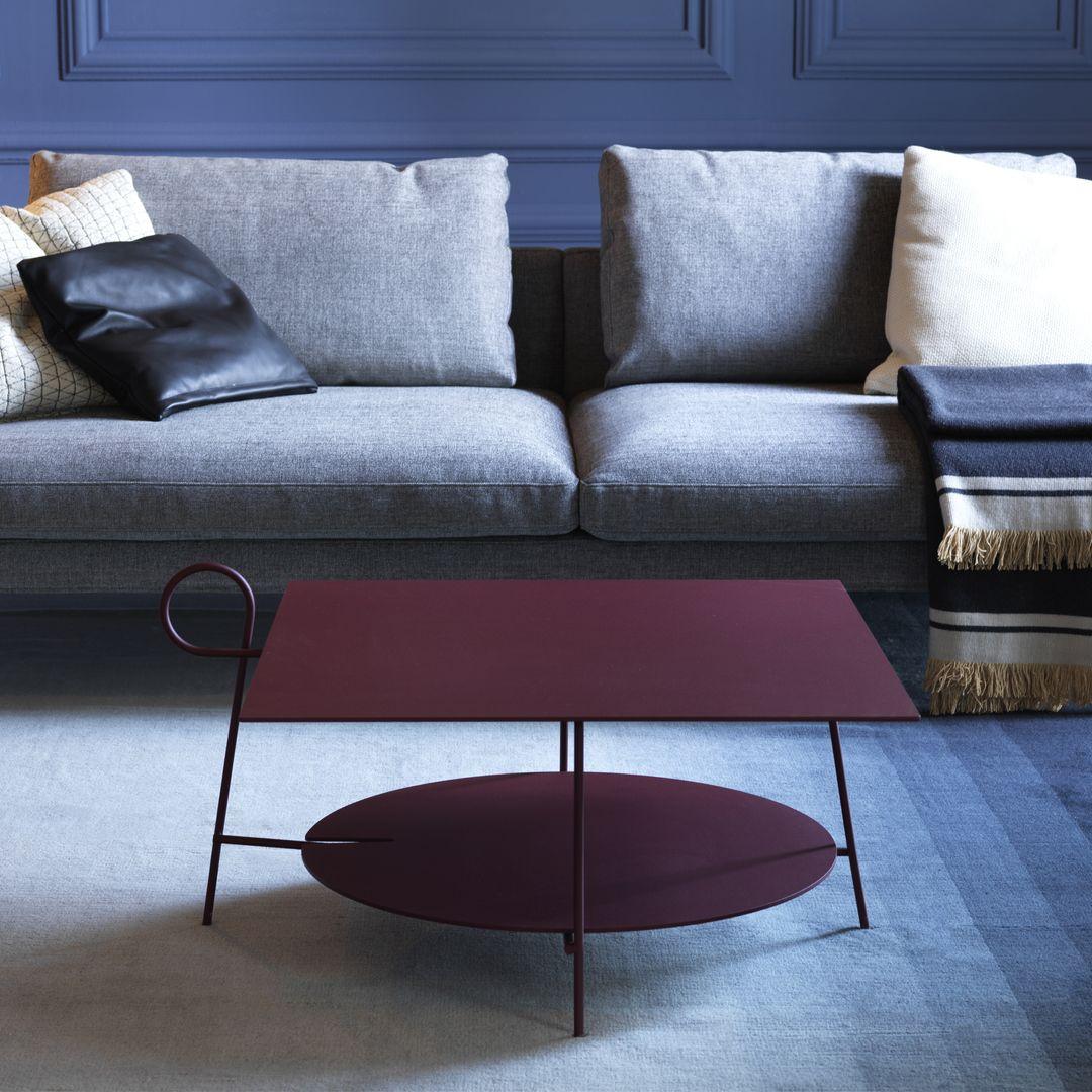 Collection of small coffee tables with a leg that daintily curls above the edge of the top. Technically speaking it is just an object - and quite a plain one at that - made of lacquered metal, but the use of colour and this charming poetical gesture