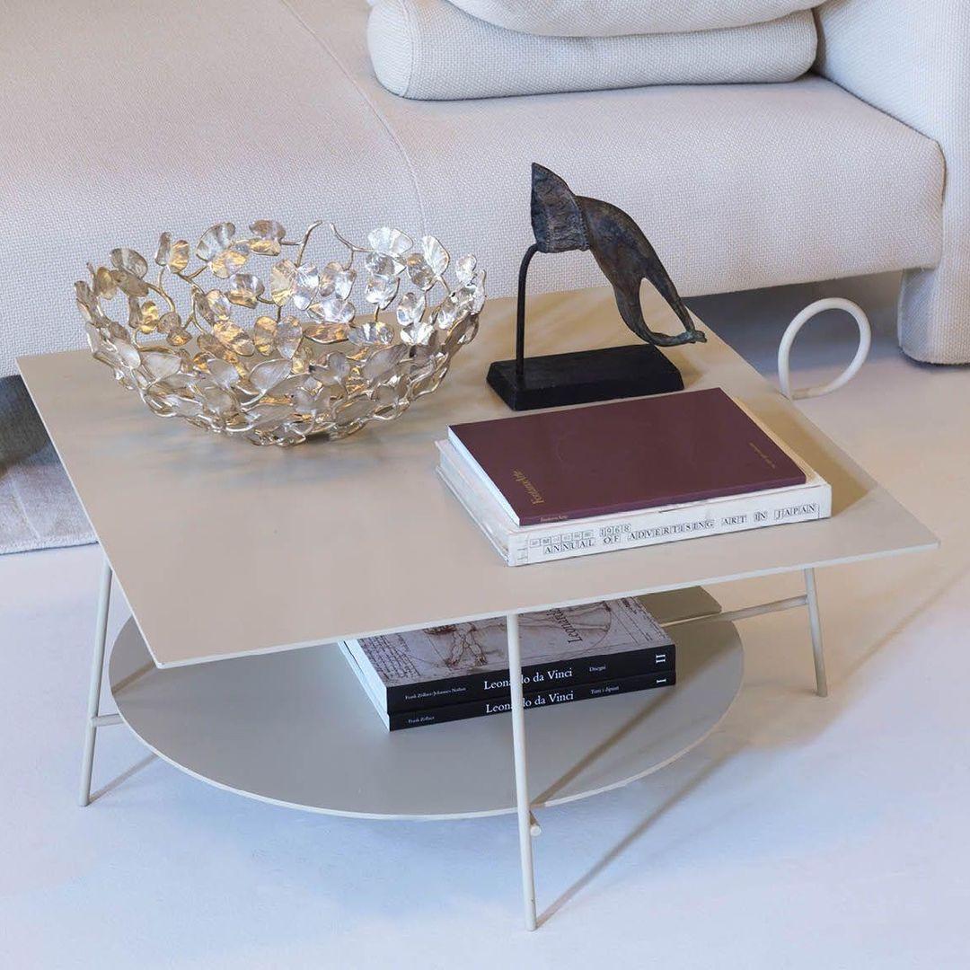 Collection of small coffee tables with a leg that daintily curls above the edge of the top. Technically speaking it is just an object - and quite a plain one at that - made of lacquered metal, but the use of colour and this charming poetical gesture