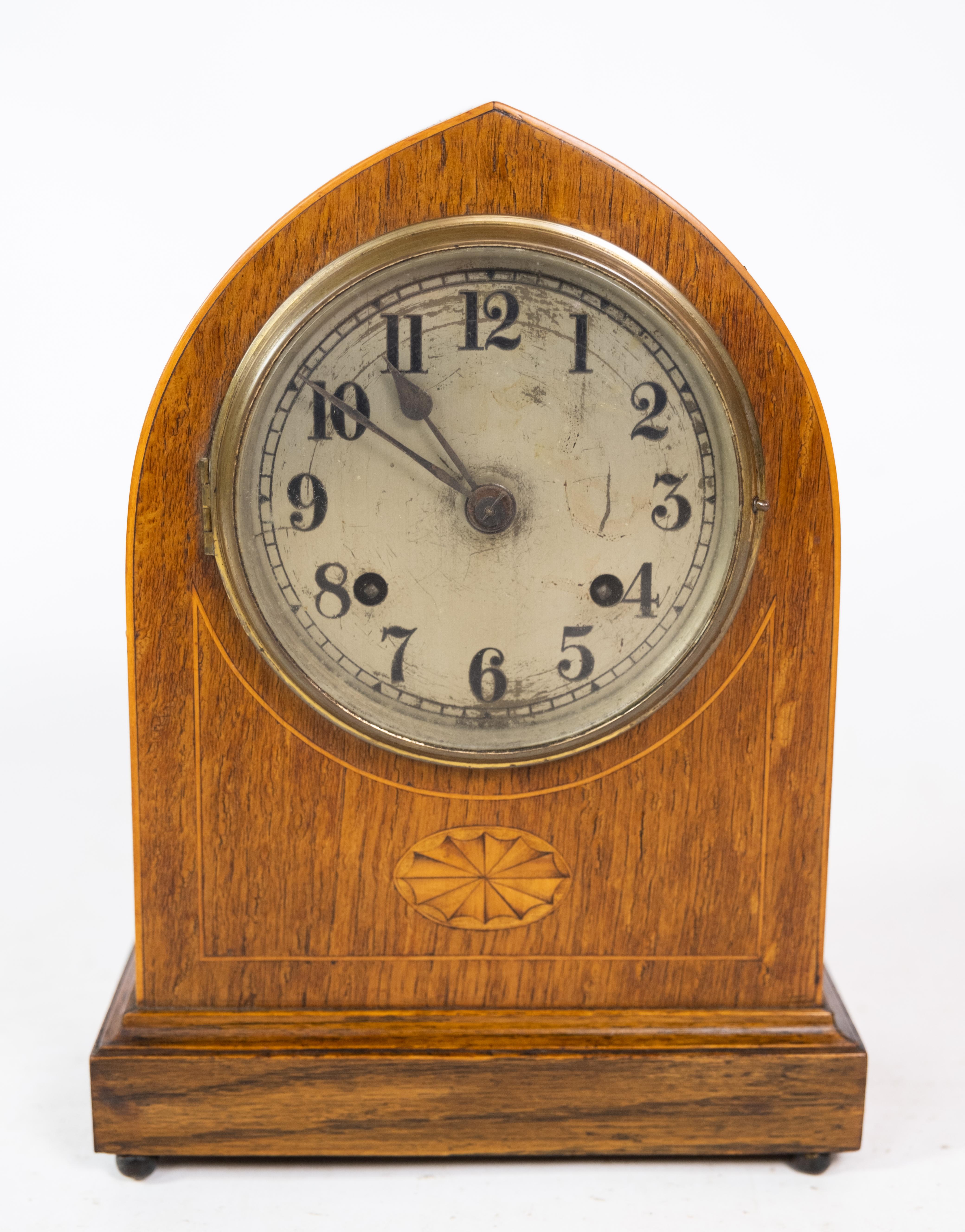 Antique carmine clock in light mahogany with intarsia from around the 1920s.

This product will be inspected thoroughly at our professional workshop by our educated employees, who assure the product quality.