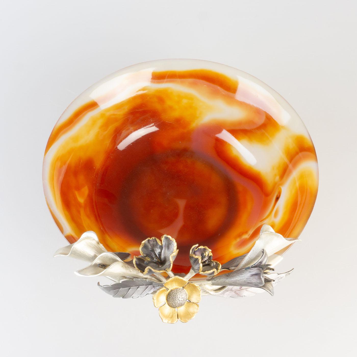 Carnelian Agate tumbler with antiqued silver flowers. This beautiful stone from Brazil takes on the typical red coloring due to the presence of iron with shades of orange, yellow, and white that sharpen depending on the light and because of these
