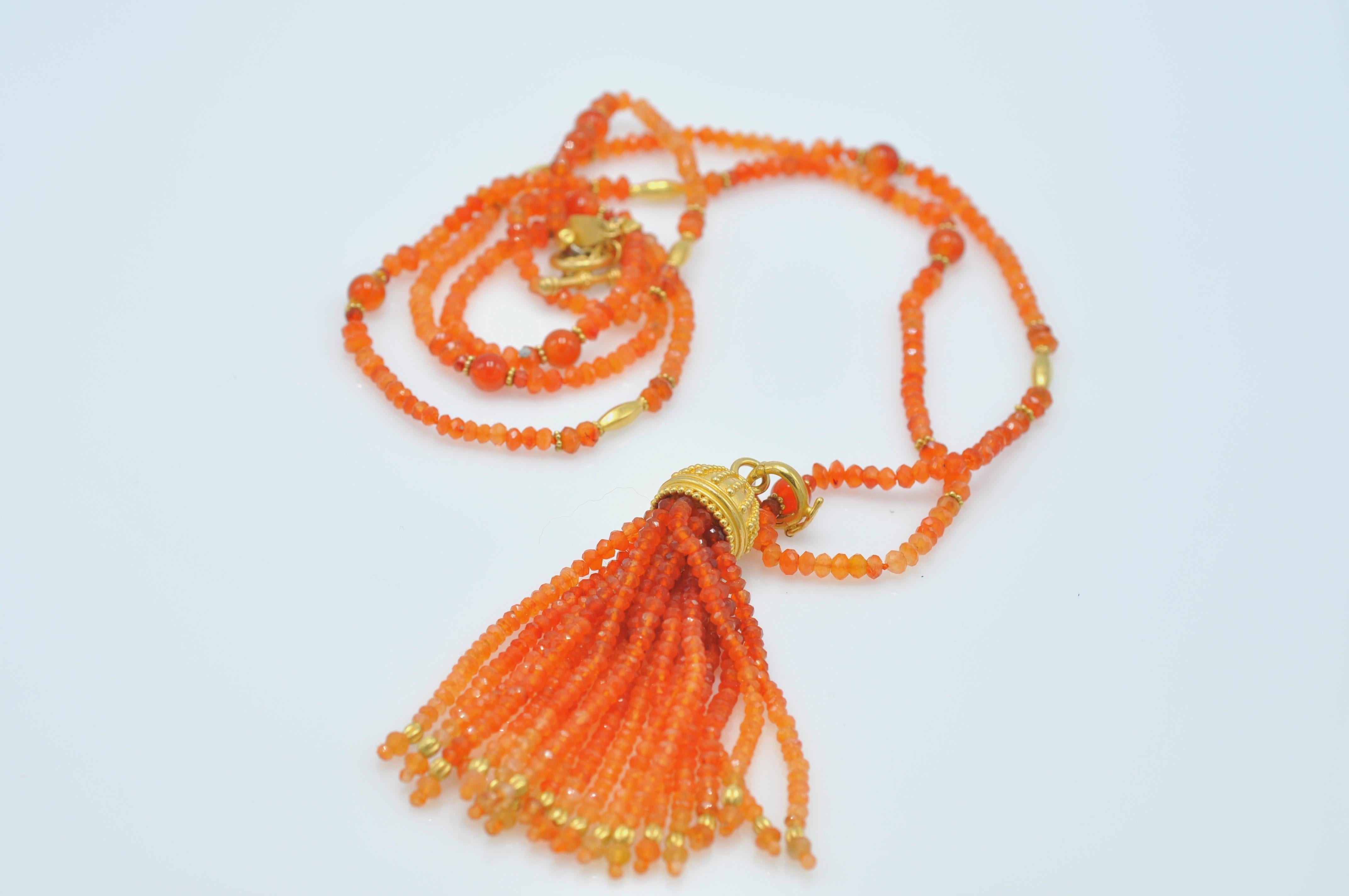 Carolyn Tyler-designed, faceted carnelian bead necklace with 18K Yellow Gold accents. The necklace measures 36 inches long and the Tassel measures 3 inches long. The necklace can be worn with or without the tassel, thereby adding to its versatility.