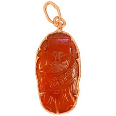 Carnelian Carving of Lucky Chinese Deity Framed in Large Rose Gold Pendant