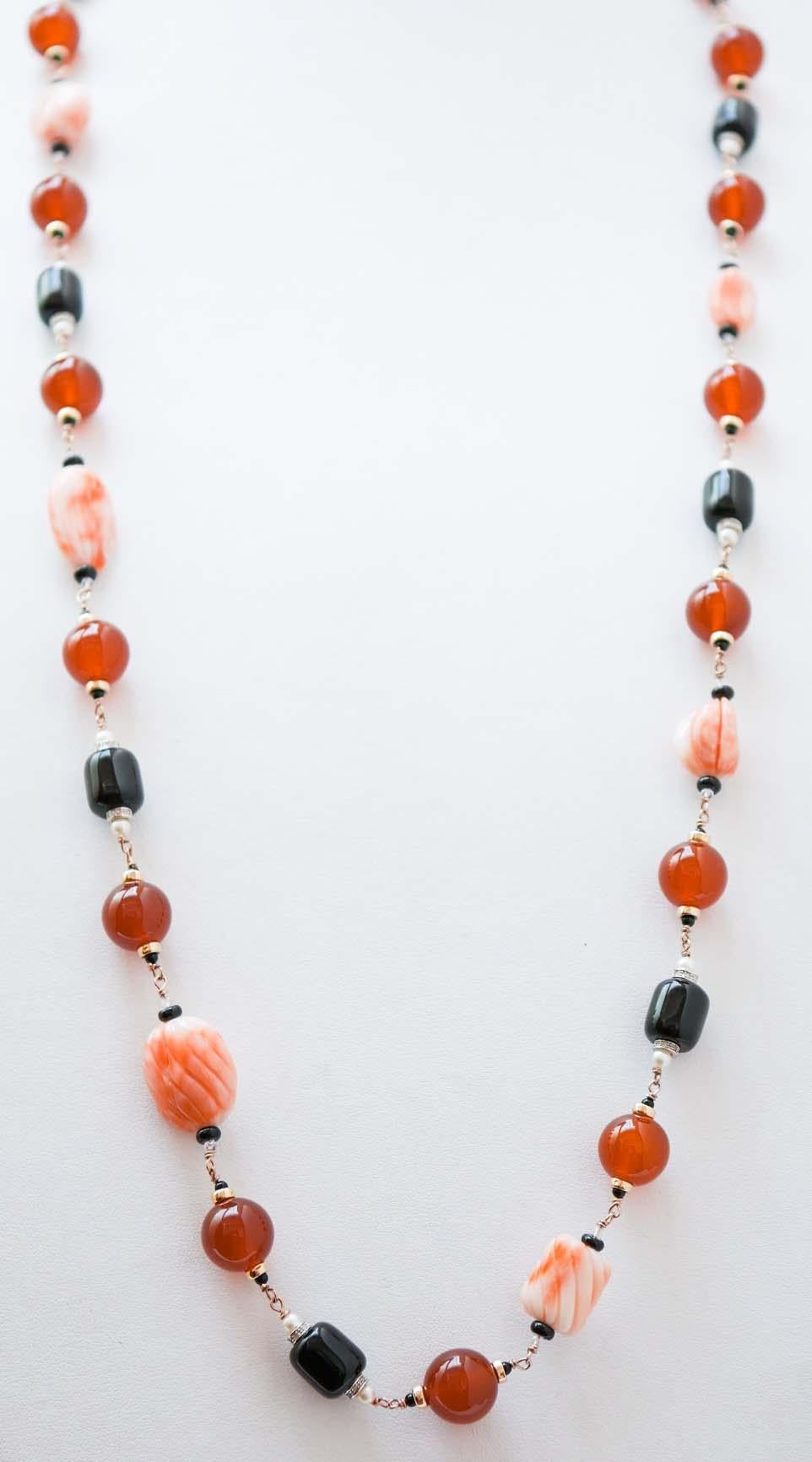 Fantastic necklace in 9 kt rose gold structure mounted with sections of coral, carnelian ,pearls and onyx, Between of them, structure in 9 kt white gold studded with diamonds and little structures in 14 kt rose gold.
This necklace was totally