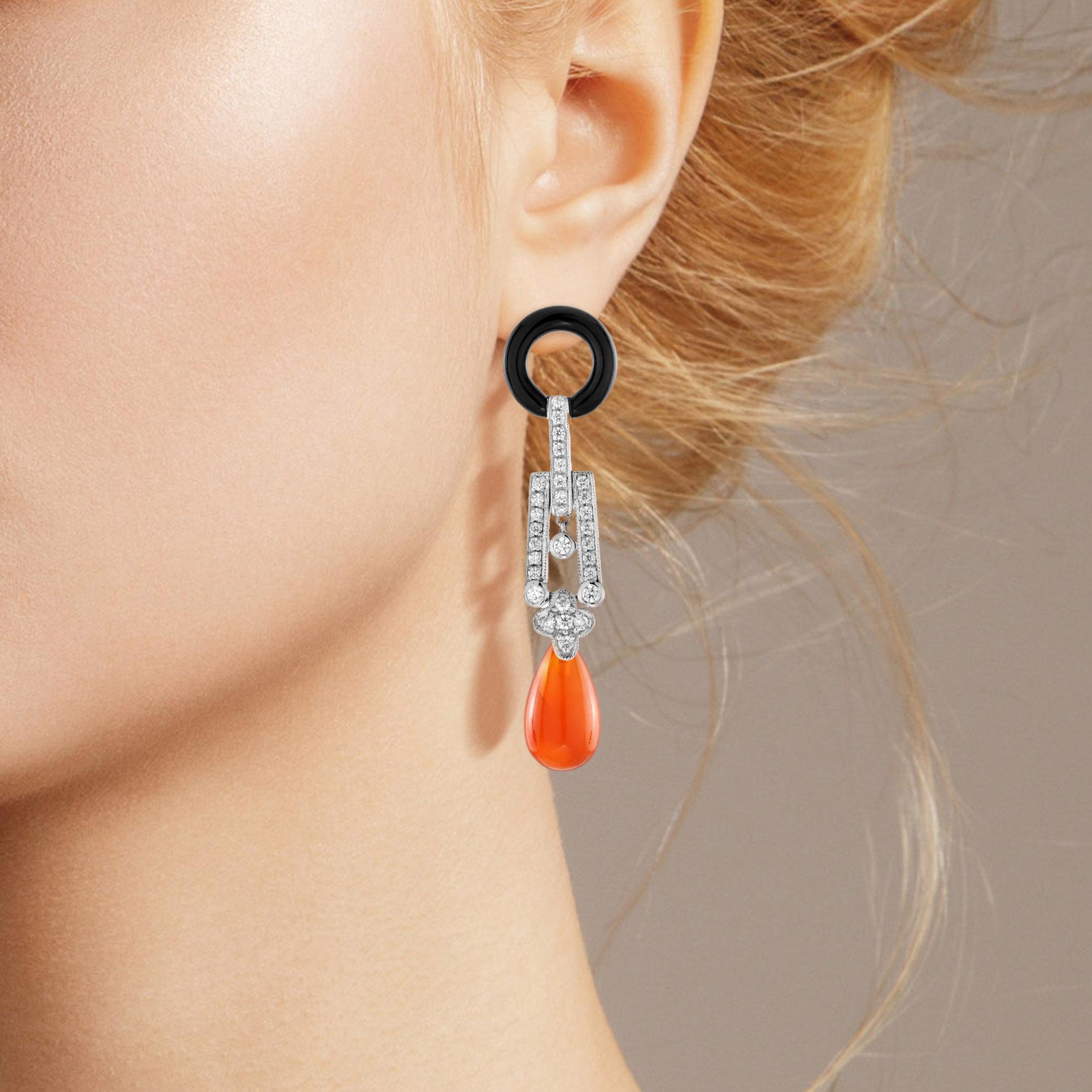 These statement earrings are Art Deco inspired handcrafted using approximately 8.00 carat teardrop shape carnelian. The upper part is decorated with shimmering diamonds, and donut shaped black onyx. Create your signature look with these lovely