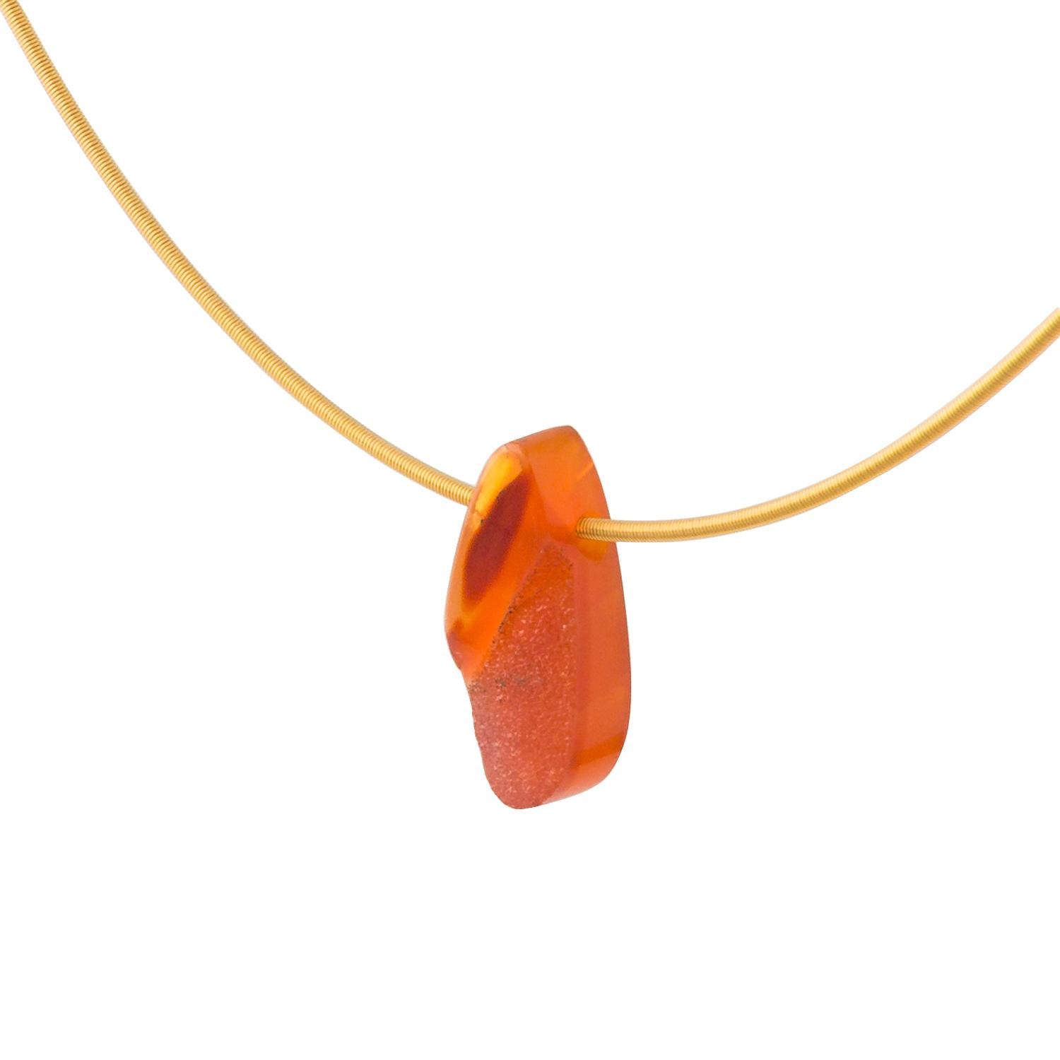 Handmade in our Northern Irish workshop this necklace is made from a hand carved piece of orange red Carnelian, hung on an 18 Karat yellow Gold circular necklace. A contemporary piece: simple and uncluttered.

Carnelian is the birthstone for Taurus,