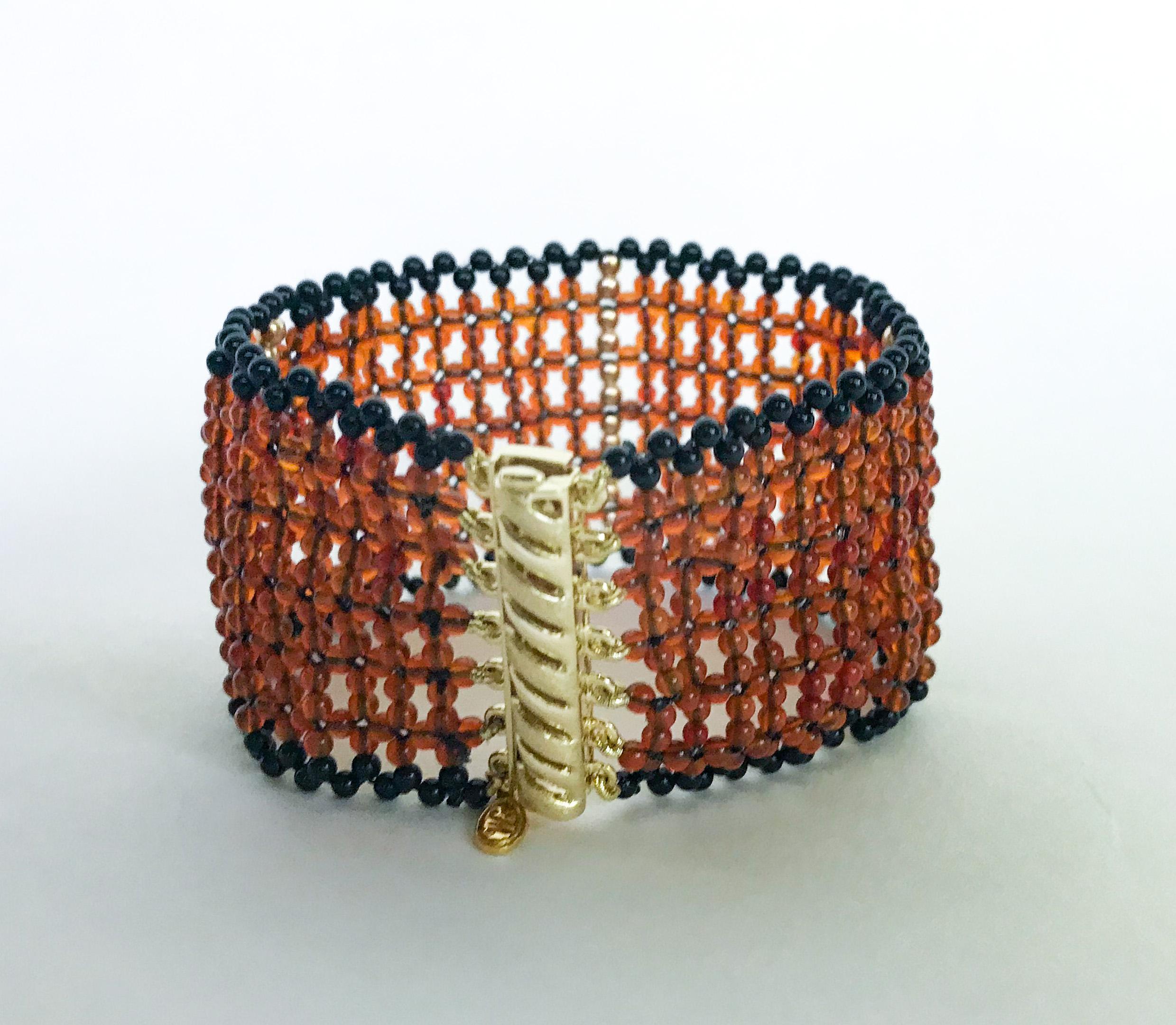 This unique bracelet is 6.5 inches long and 1.25 inches wide. It is made with 1.5 mm carnelian, onyx beads , and 14k gold beads that are 2 mm. The clasp is sterling silver and 14k gold-plated, and very secure and easy to use. The bracelet is woven