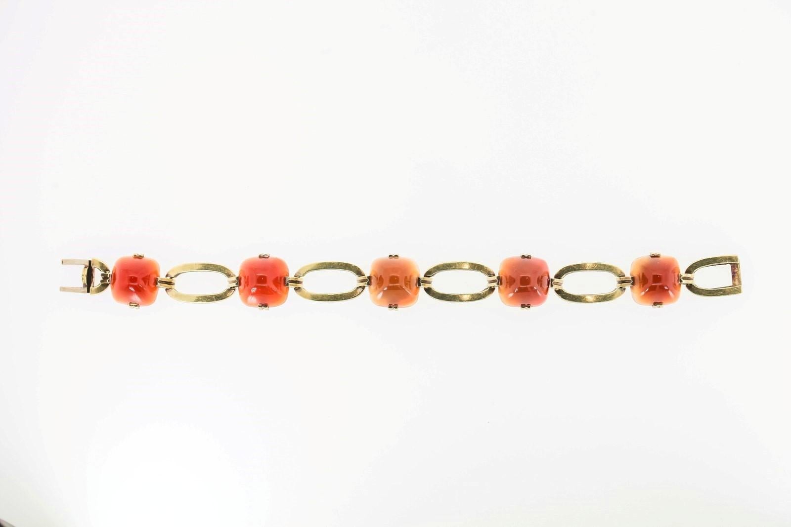 Created in 14KT yellow gold this unique Retro bracelet flaunting five sugar loaf cut Carnelians joined by open oval links.  The bracelet measures 7 inch long  with a tongue and groove closure signed 