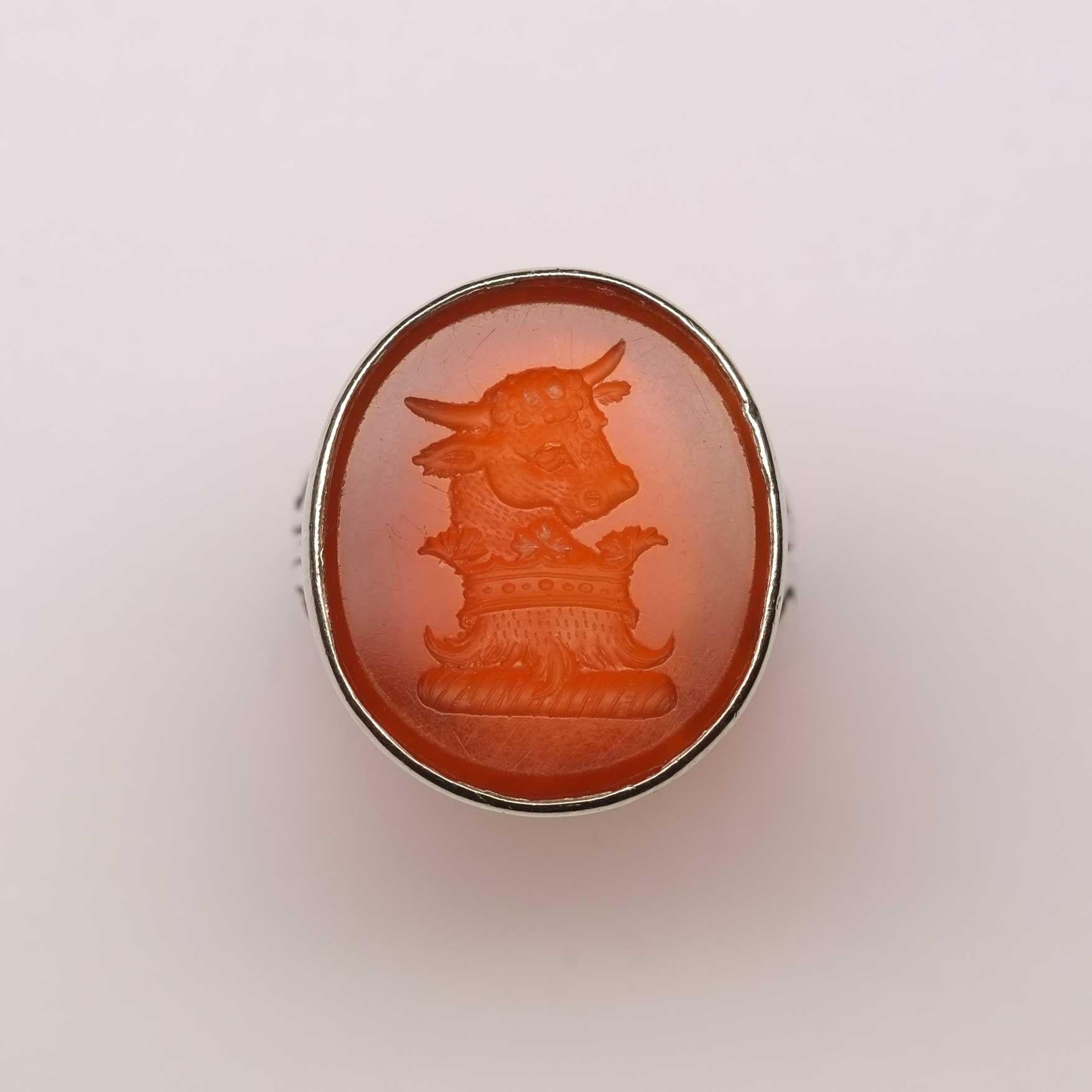 Carnelian intaglio ring set in silver depicting a bull.

Highlights
- Carnelian
- Silver ring setting

Measurements
- Length 1.9cm x Width 2.2cm
- Italian ring size 12 (size can be altered if required)