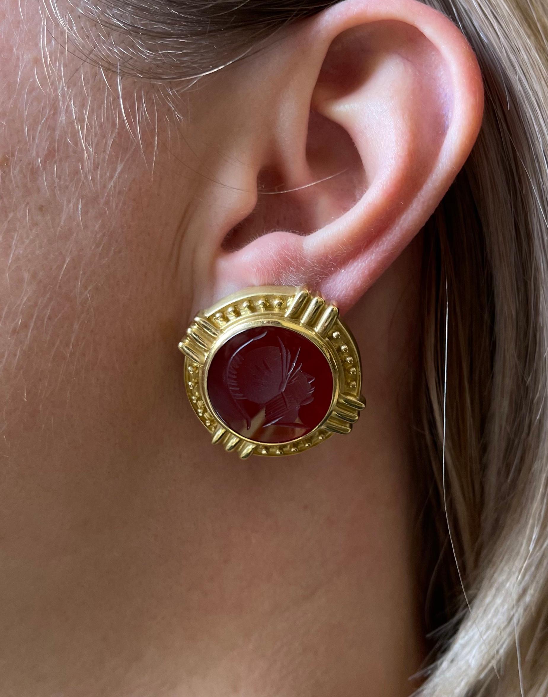 Pair of large 18k gold earrings, set with carnelian intaglios, depicting Roman warrior profile. Earrings measure 1.25