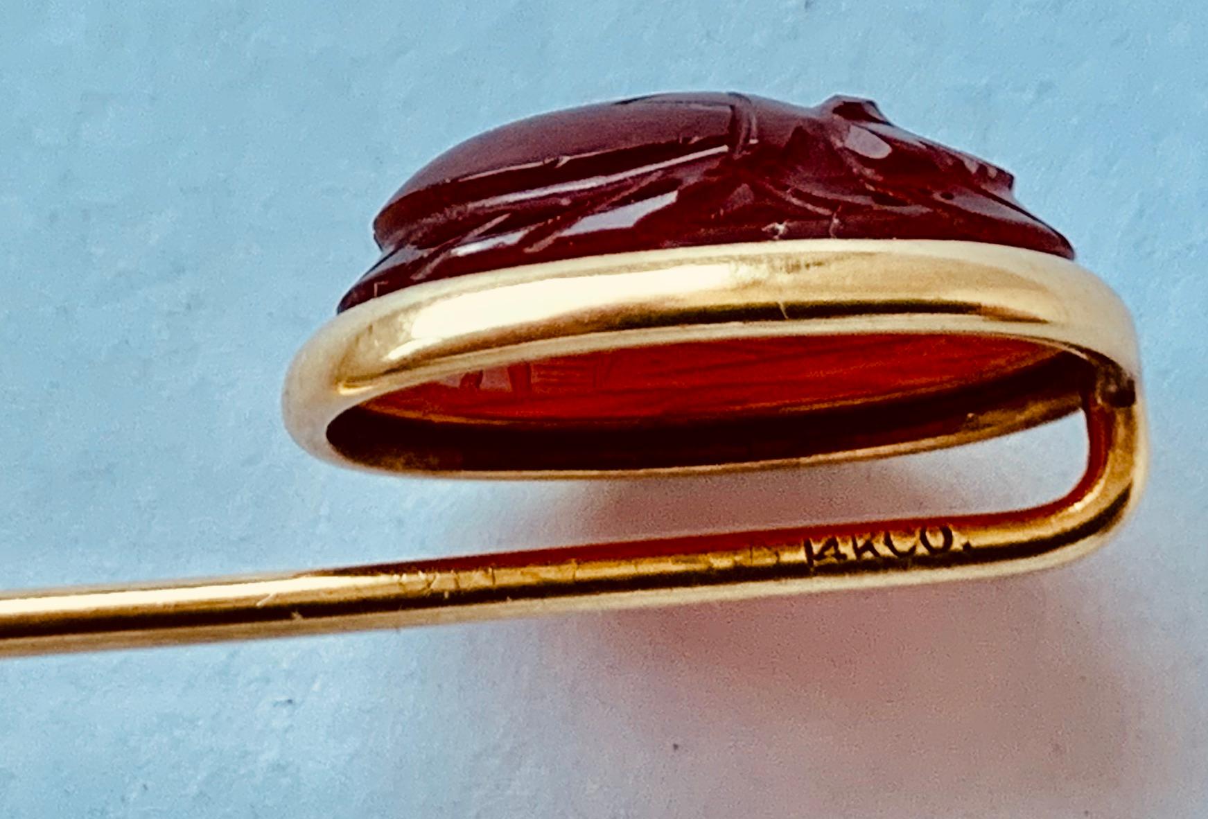 Gentlemen's 14k yellow gold stickpin with an oval cabochon carnelian hand carved to resemble an Egyptian scarab.  If you don't wear it on your tie it will look great on the lapel of your jacket.  I have also seen them worn on hats and berets.  Fully