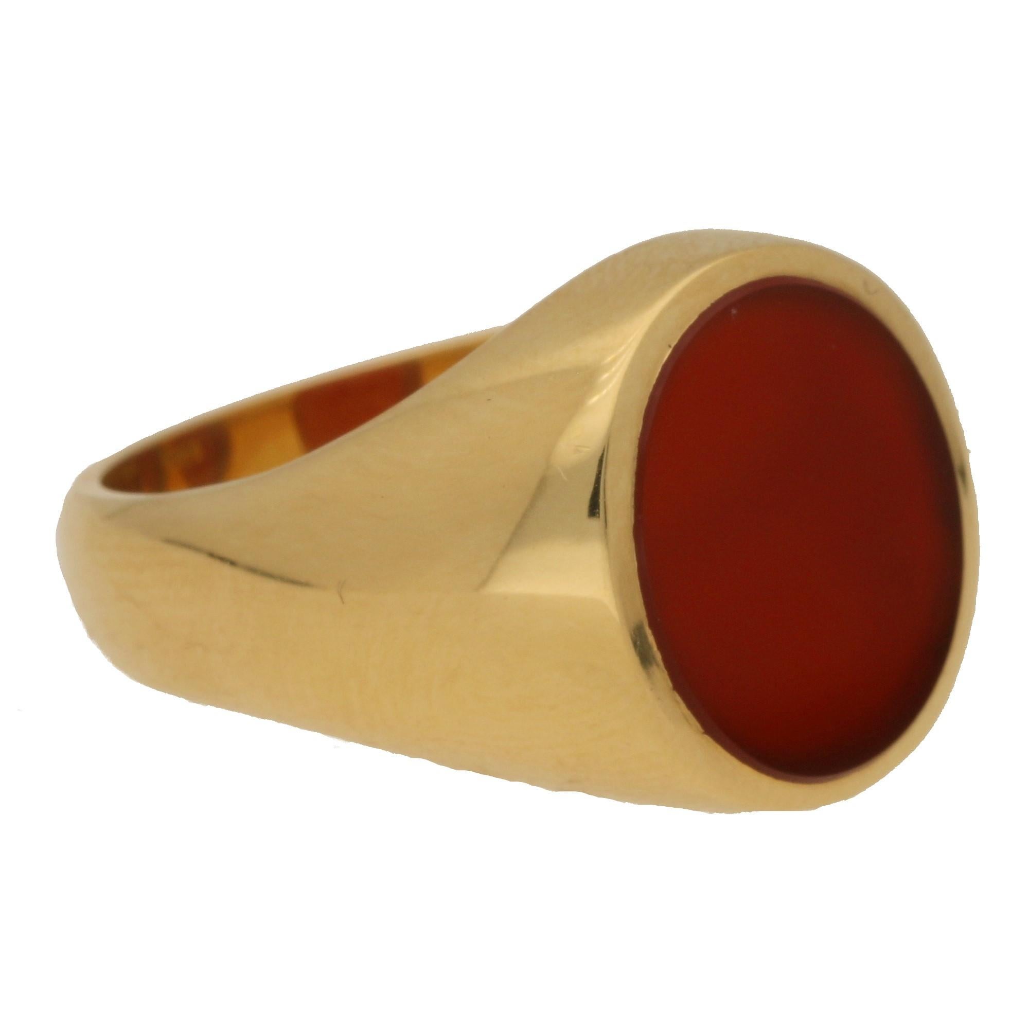 A striking oval signet ring set with an orange-brown coloured carnelian stone made of solid 18k yellow gold.

The ring head measures approximately 12 x 10mm and the stone has been left bare so that the wearer has the option to customise it in the