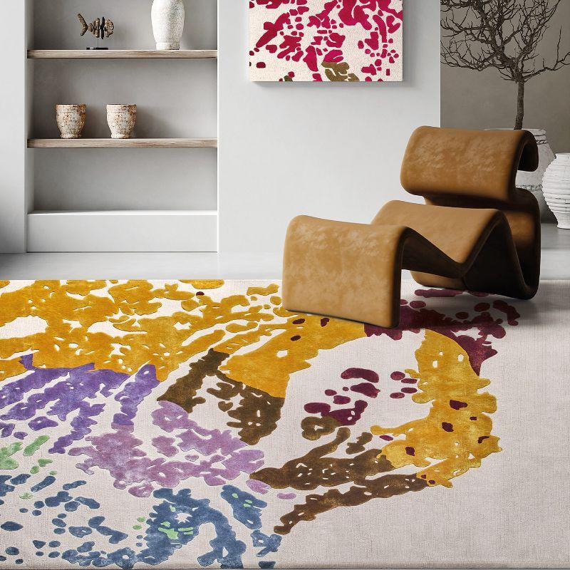 A stunning tribute to Venice and its iconic Mardi Gras celebrations, the Carnival rug by Tommaso Ceschi showcases a characteristic mask design in gorgeous hues of red, gold, green, and lilac on a shimmering white background. Handcrafted in India