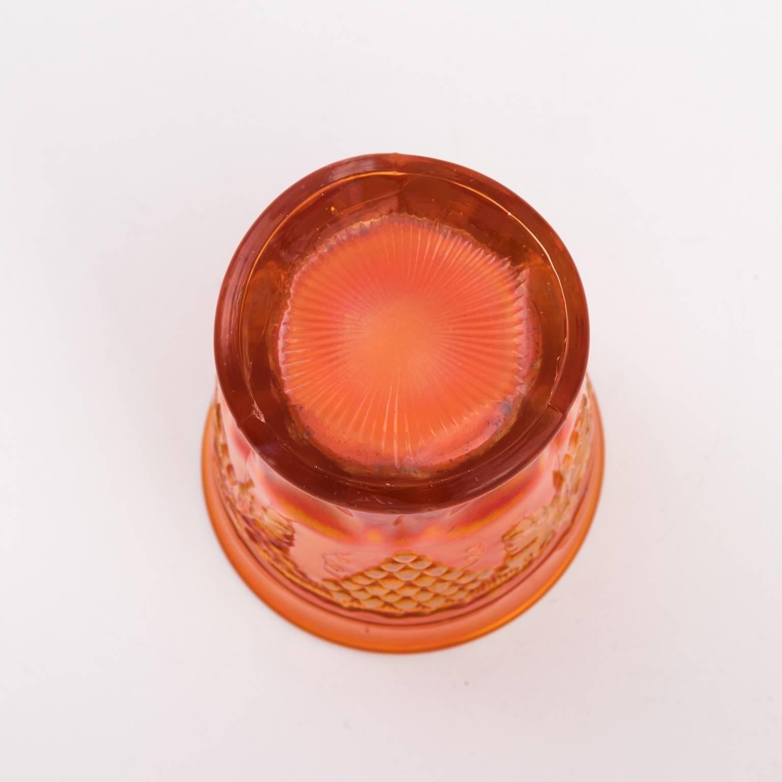 Signed Northwood-Marigold, circa 1900. The measurements for the pitcher are 8.50 inches height by 8.00 inches diameter; the measurements for the tumblers are 4.00 inches height by 3.00 inches diameter.
 