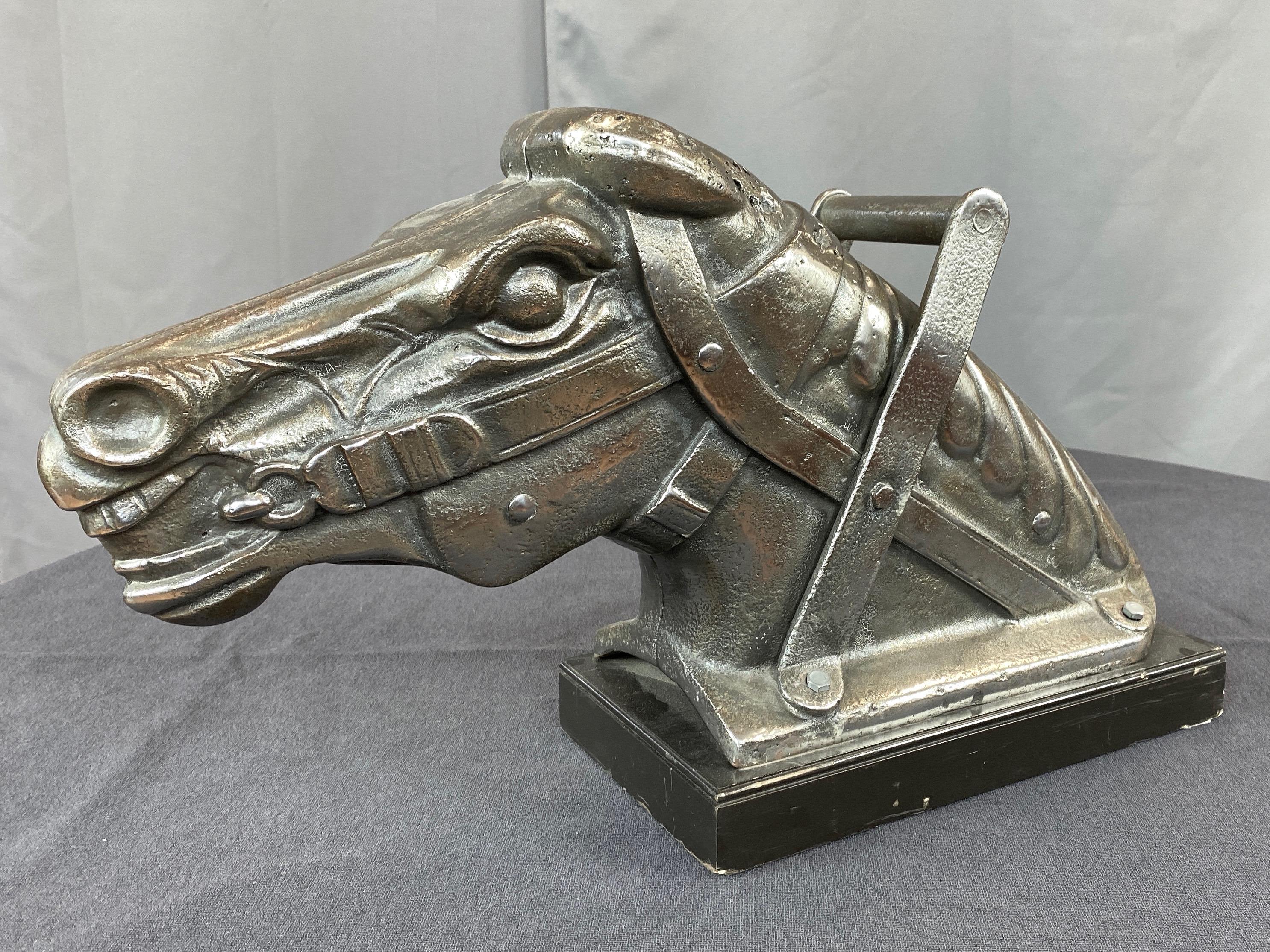 An impressive and uncommon polished cast iron horse head from a circa 1930s carnival kiddie ride or carousel.

Wonderfully expressive sculpt captures your noble steed at full gallop, with eyes ablaze, nostrils flared, and teeth bared as it strains