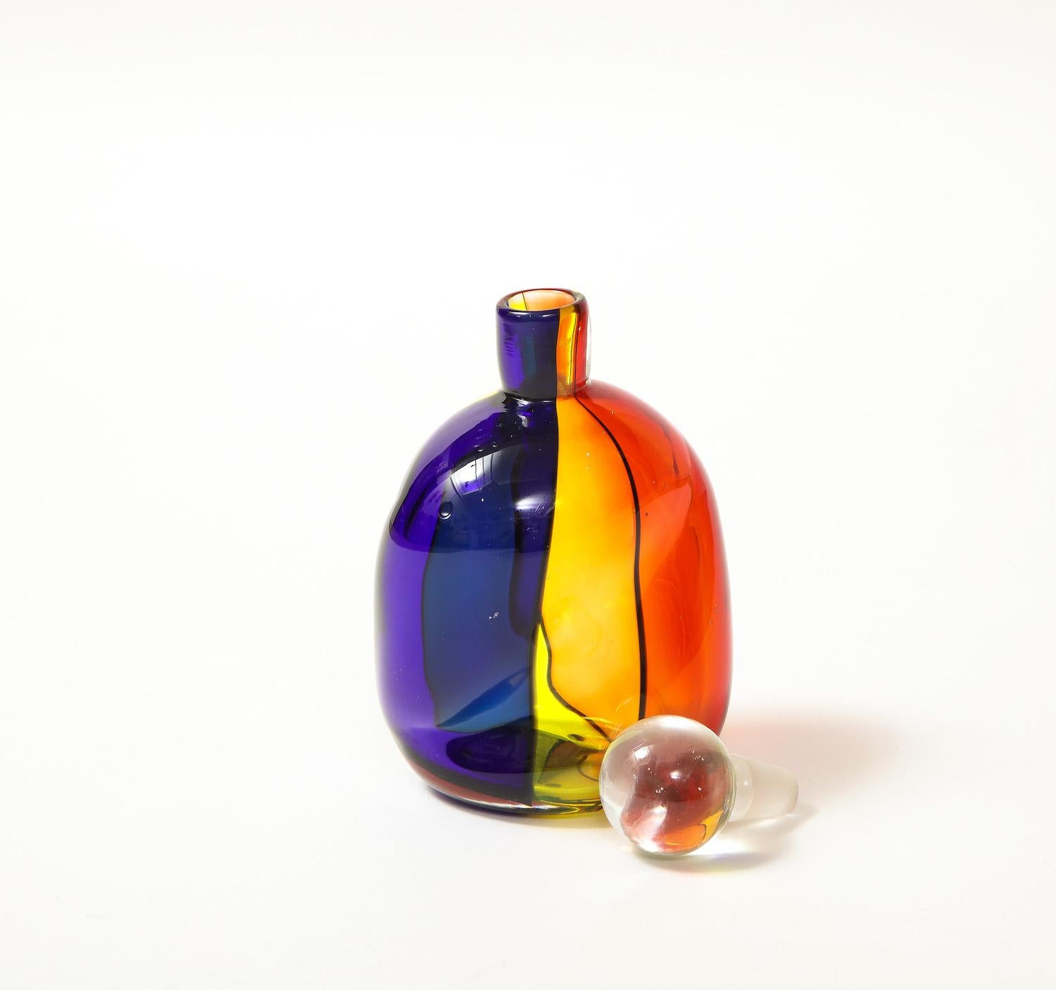 Handblown glass stopper bottle of twisted form & bands of color.