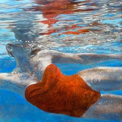 "Rachael in Suspense" Woman floating in water in orange one piece swimsuit.