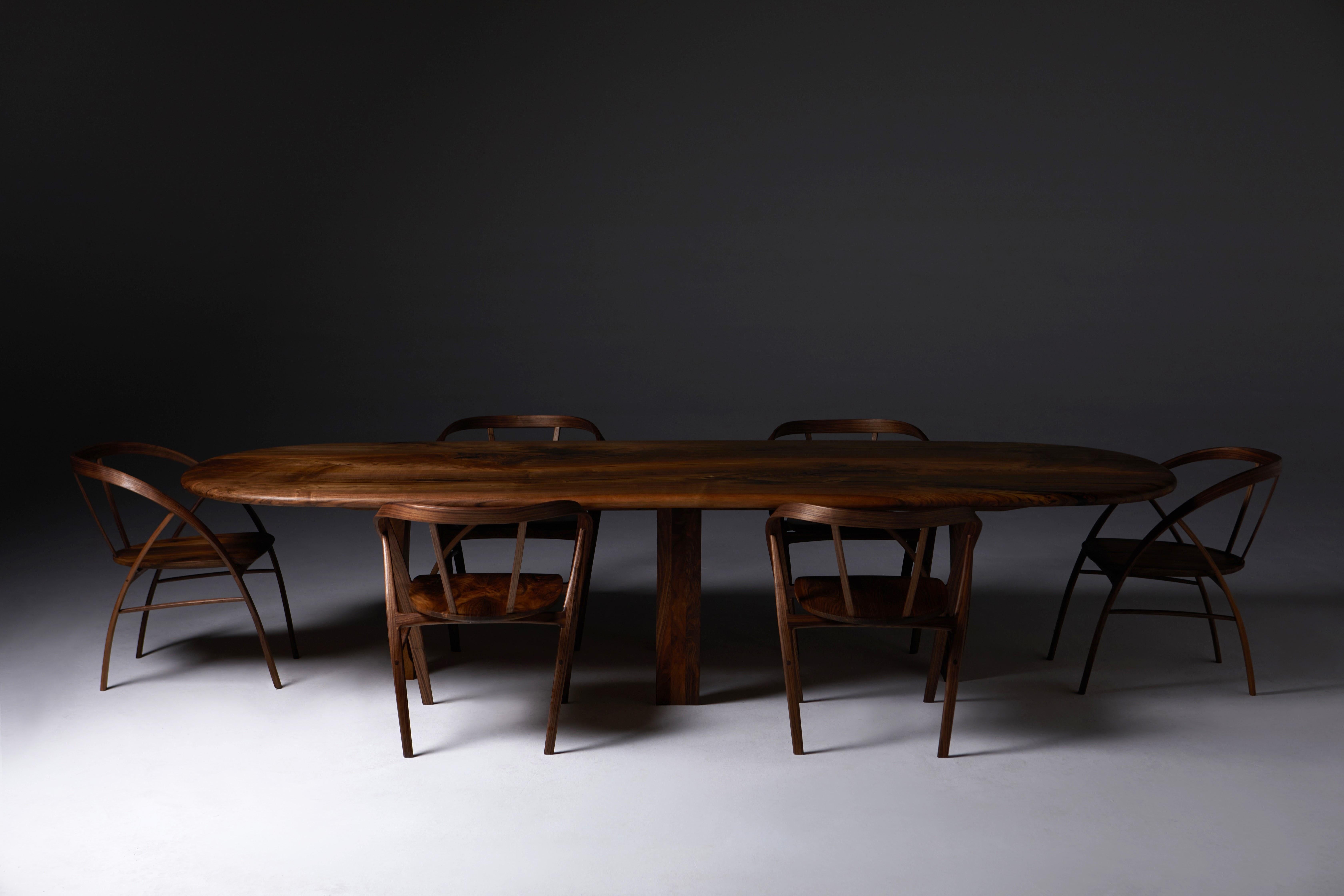 12 Carol Chairs (smaller version ) and the Oval pebble edge Table in walnut, 14ft x 4 ft. to the same design as  Item Ref: LU2899326437372.

The Sister Carol chair is a new smaller version, completed in Jan 2024, of the original Carol Chair launched
