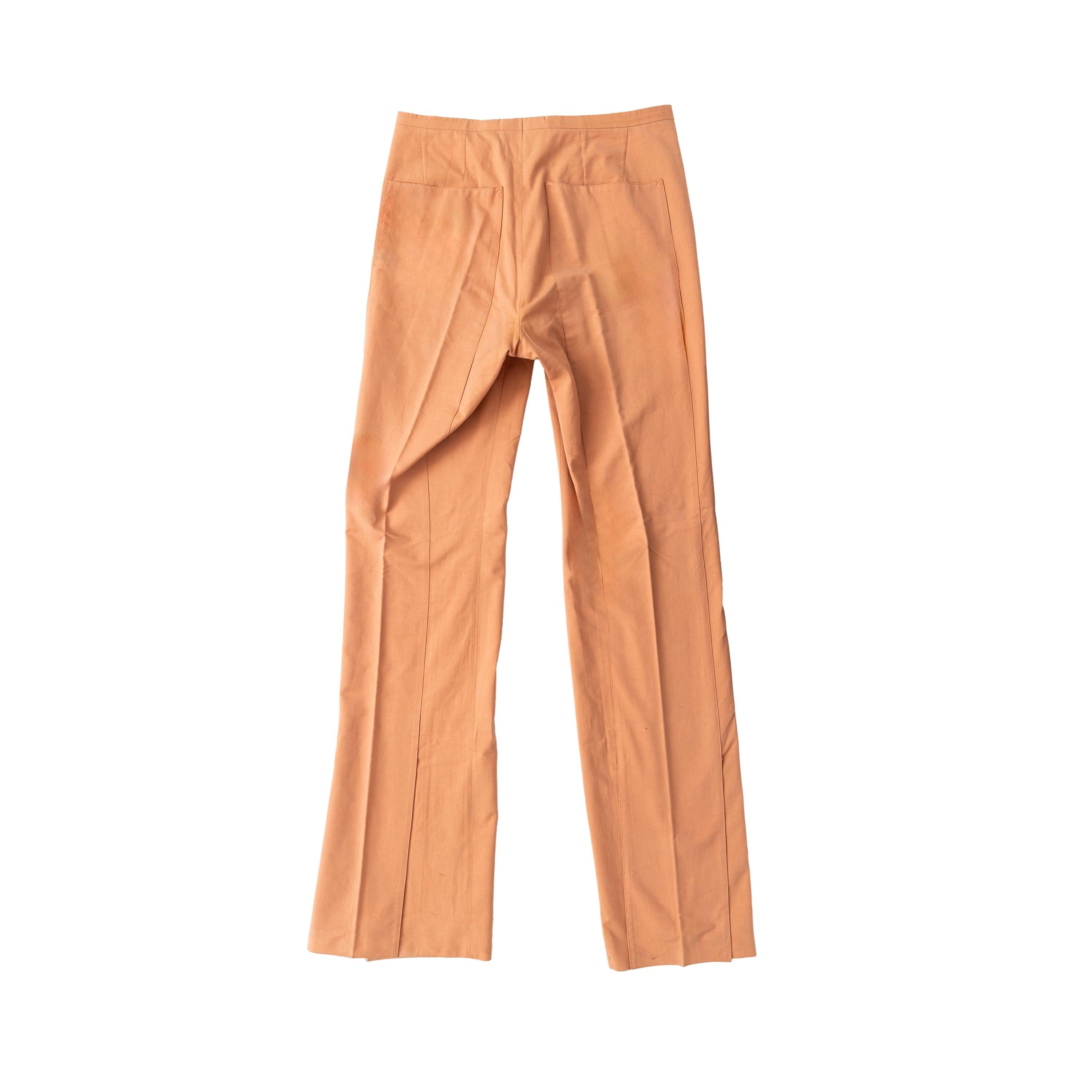 Expertly crafted from 100% cotton in a salmon orange hue, these pants by Carol Christian Poell offer a long, straight fit. The unique panel at the hem adds a touch of avant-garde design, while the zip and button closure with a grey lining expansion