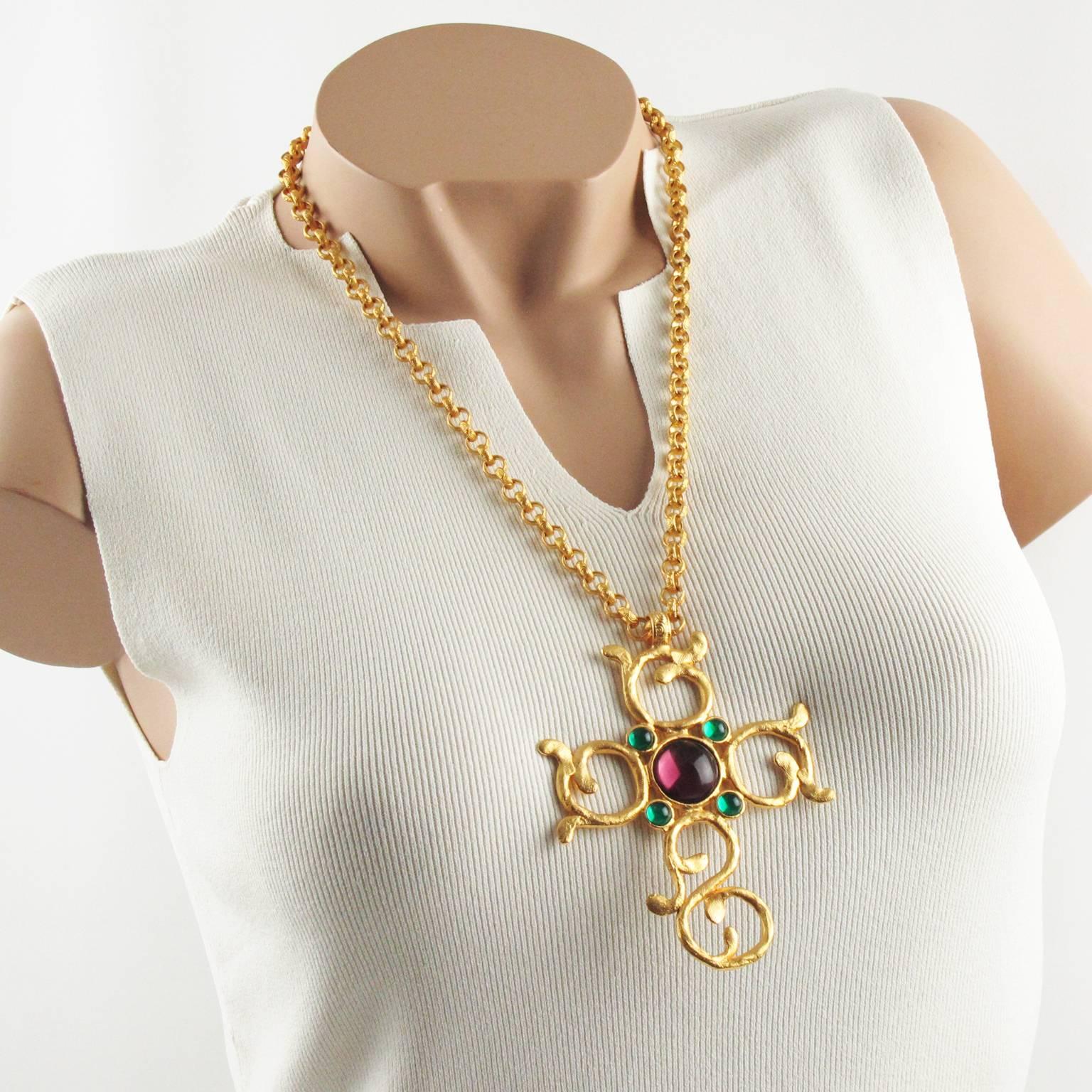 Elegant Carol Dauplaise openwork gilt metal cross pendant necklace. Featuring a huge hand-made feel carved and see thru modernist cross pendant, ornate with poured glass cabochon in purple plum and emerald green color. Original long and heavy worked