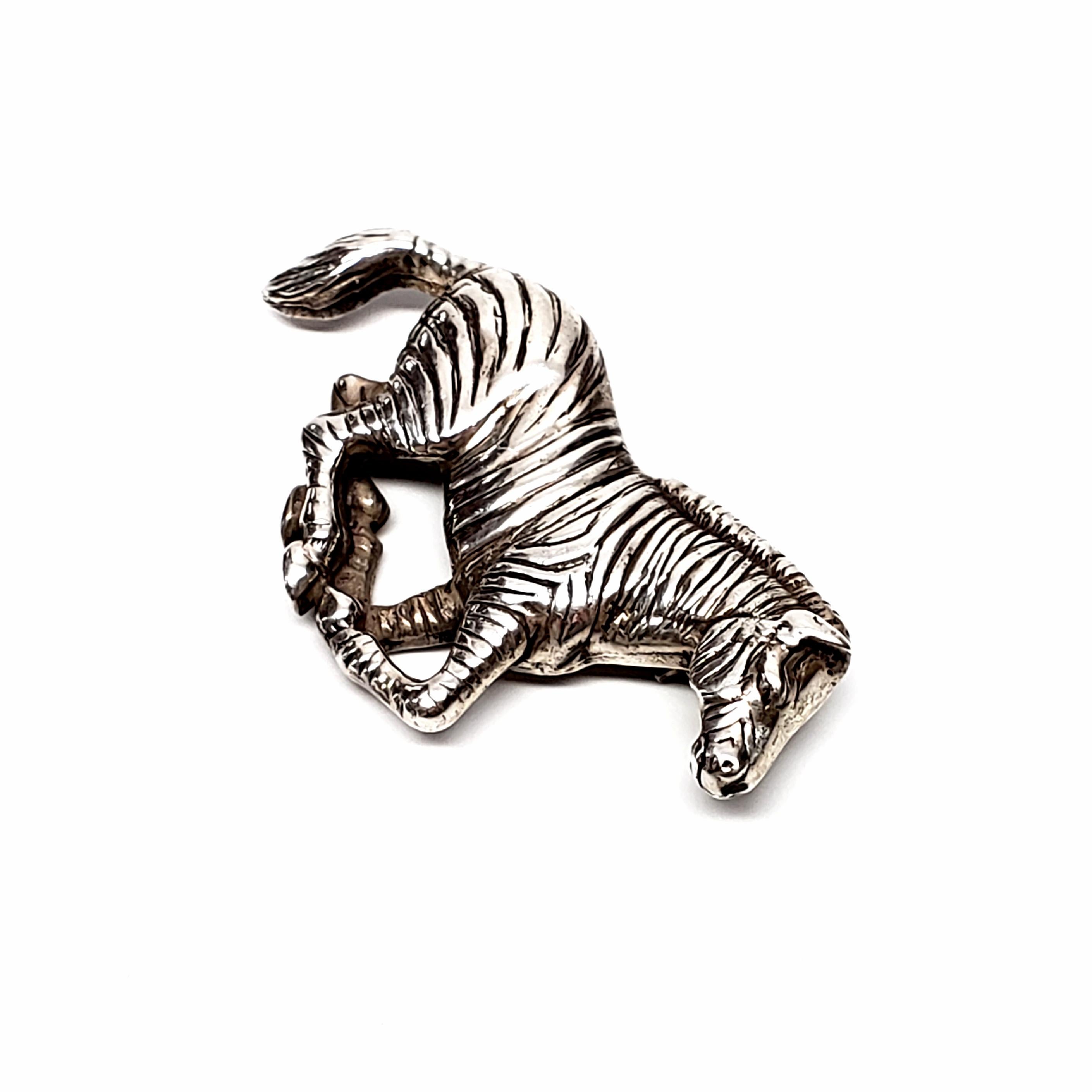 Vintage Carol Felley '91 sterling silver running zebra pin.

Southwestern designer Carol Felley, beautifully detailed zebra pin.

Measures approx 1