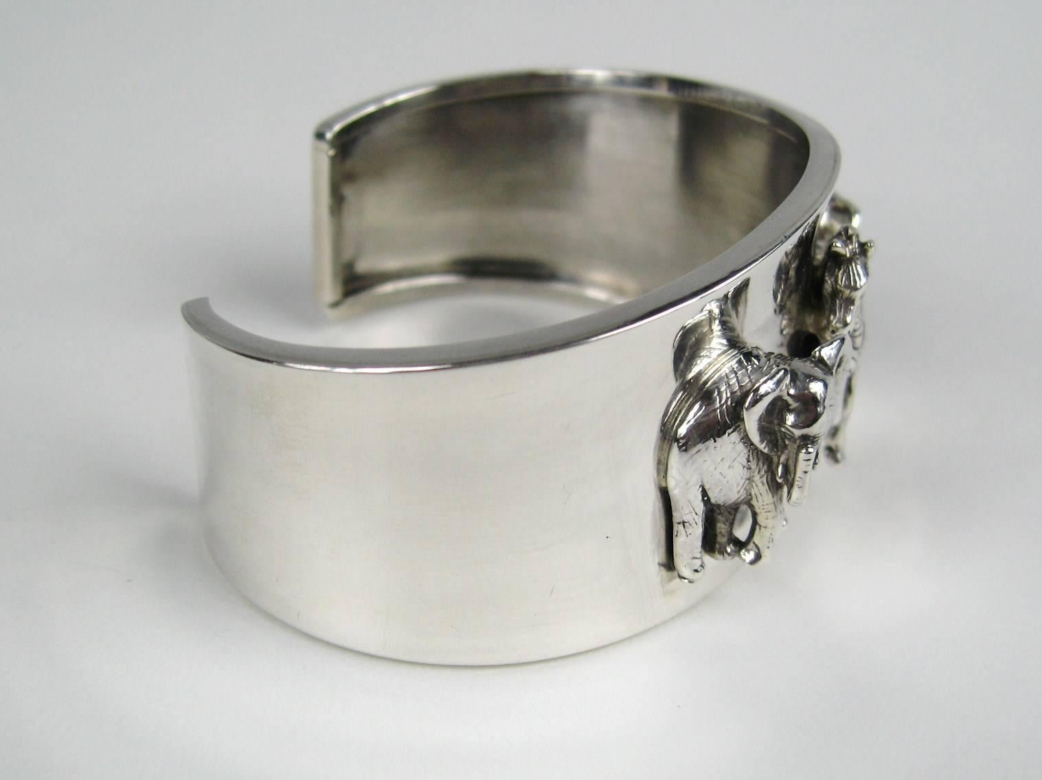 Carol Felley Sterling Cuff Bracelet featuring three 3-D Animals. An elephant on either side of the Zebra in the center. Hallmarked and dated inside cuff. It is an Amazing Stunning piece of Art. Art By Renowned New Mexico Artist Carol Felley.