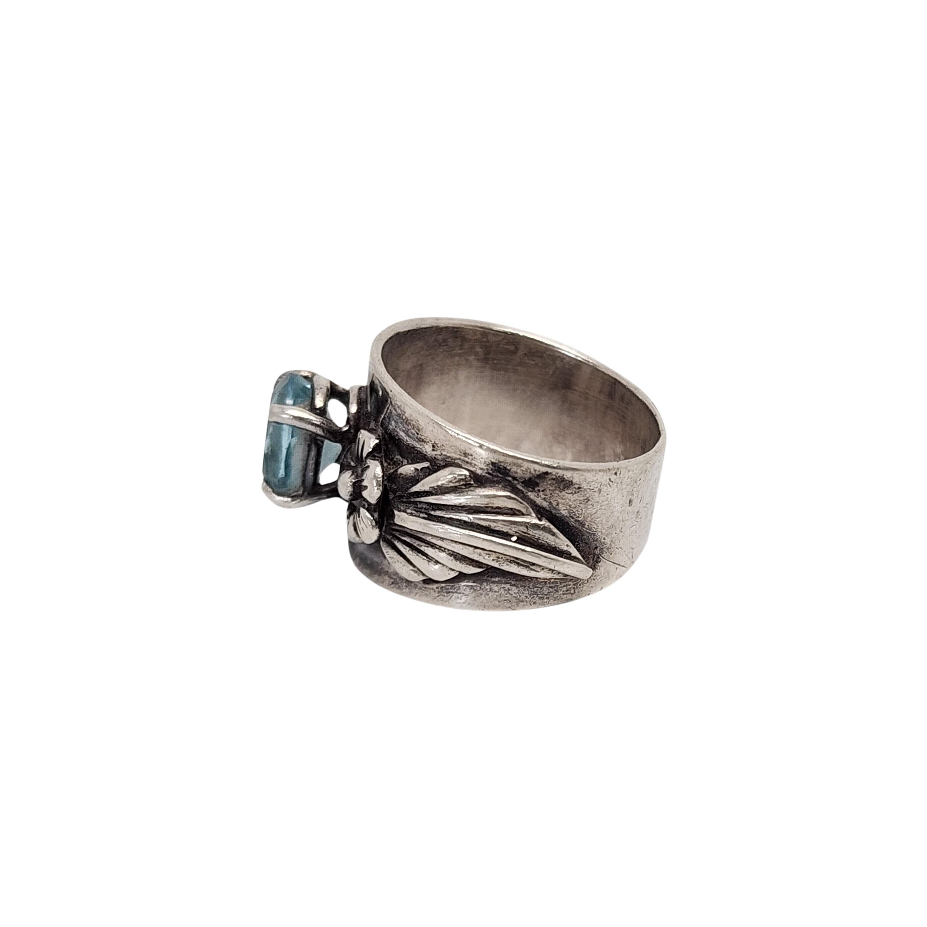 Vintage sterling silver blue topaz flower band ring by Carol Felley.

Size 6

Carol Felley is a renowned New Mexico jewelry designer that incorporates her love of beautiful symbols and natural elements. This piece features a prong set oval faceted