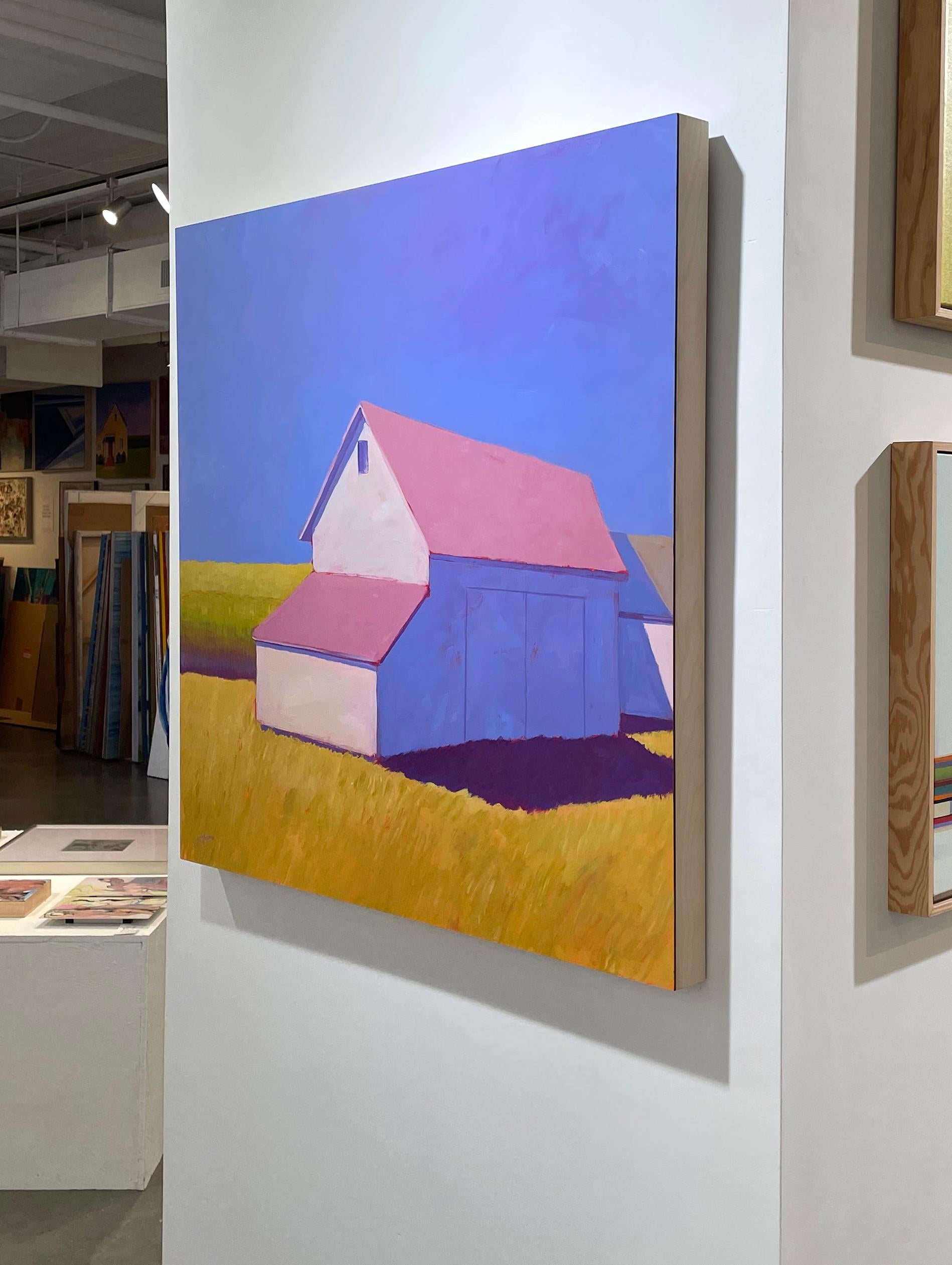 This contemporary landscape painting by Carol Young features a vibrant, saturated palette. It depicts a lightly-colored barn with a pink roof, which sits on bright gold grass and casts a cool, blue-violet shadow with a warm undertone. More rolling