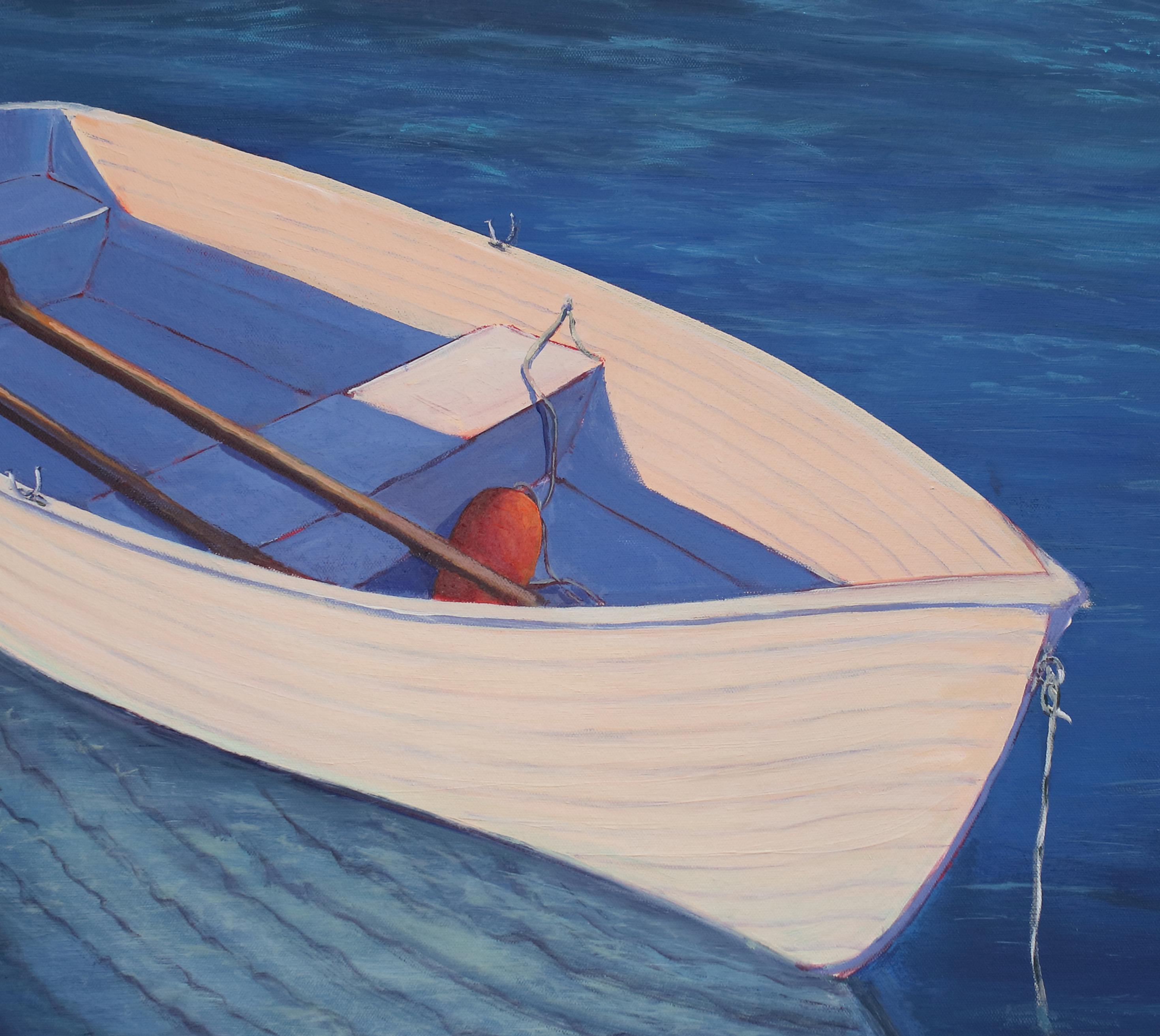 This contemporary coastal painting by Carol Young captures a small white dinghy boat, floating in deep blue water. Two red ores rest inside the boat. which casts a reflection into the water beneath it. The painting is painted in acrylic paint on