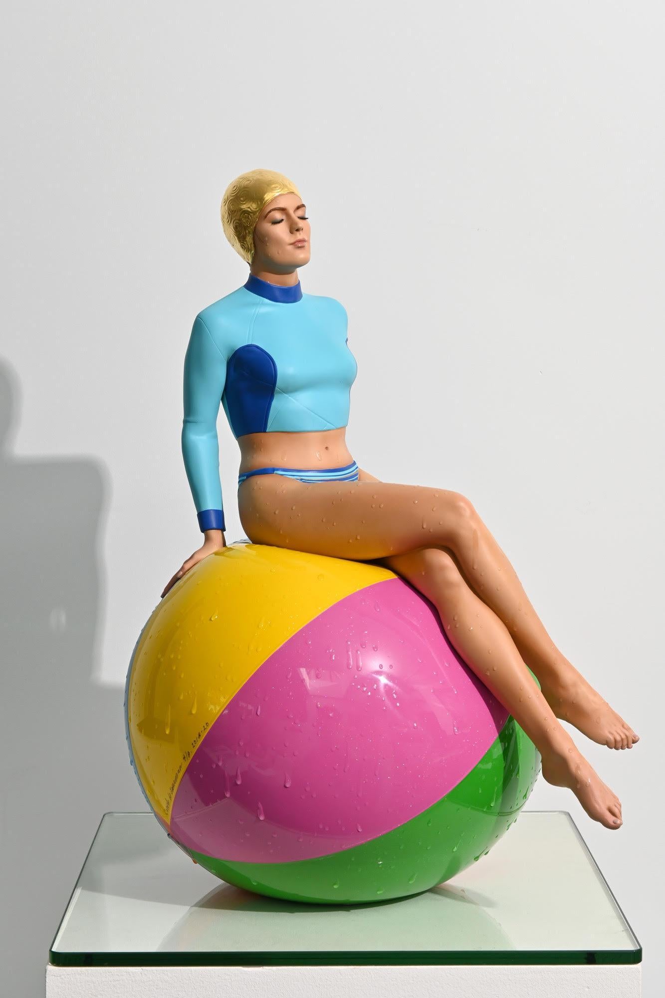 Bibi on the Ball (Table Top Scale)

Table Top Scale
Oil on Resin with 24k Gold Leaf Cap
24” x 18” x 13”
Edition of 8

Carole A. Feuerman (born 1945) is an American sculptor and author working in Hyperrealism. She is one of the three artists credited