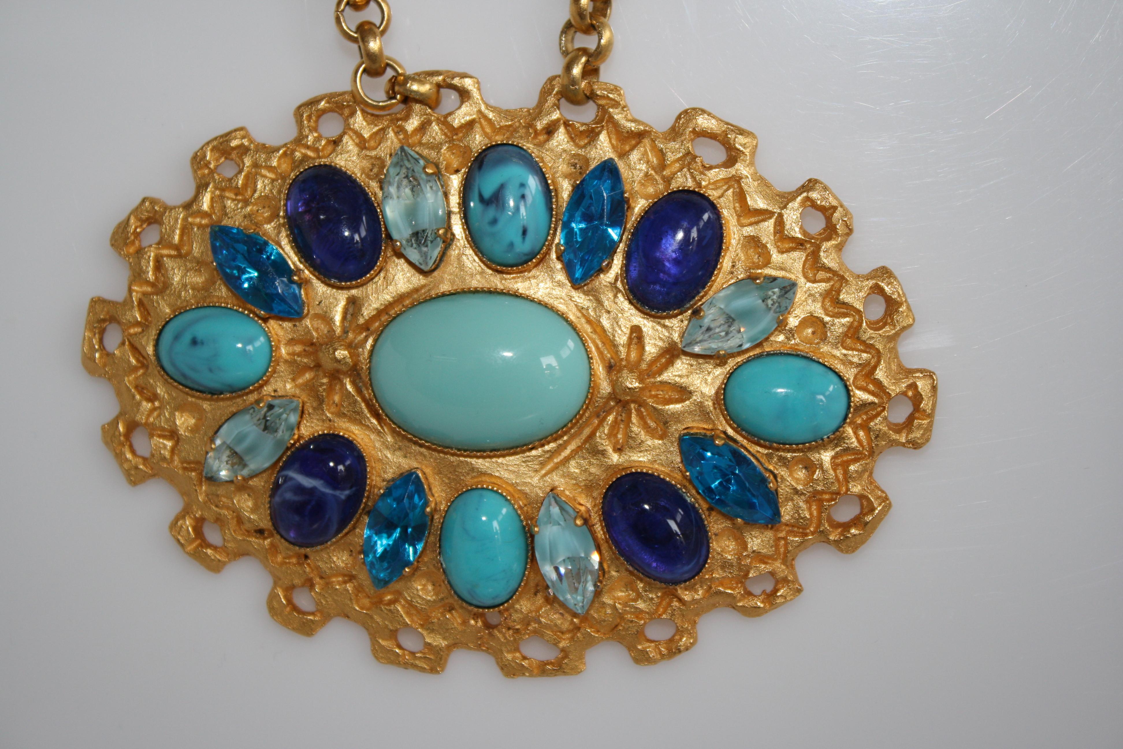 A gorgeous medallion of hammered gold with glass and crystal strung on handmade glass beads from French designer Carole St. Germes. 

Pendant is 4