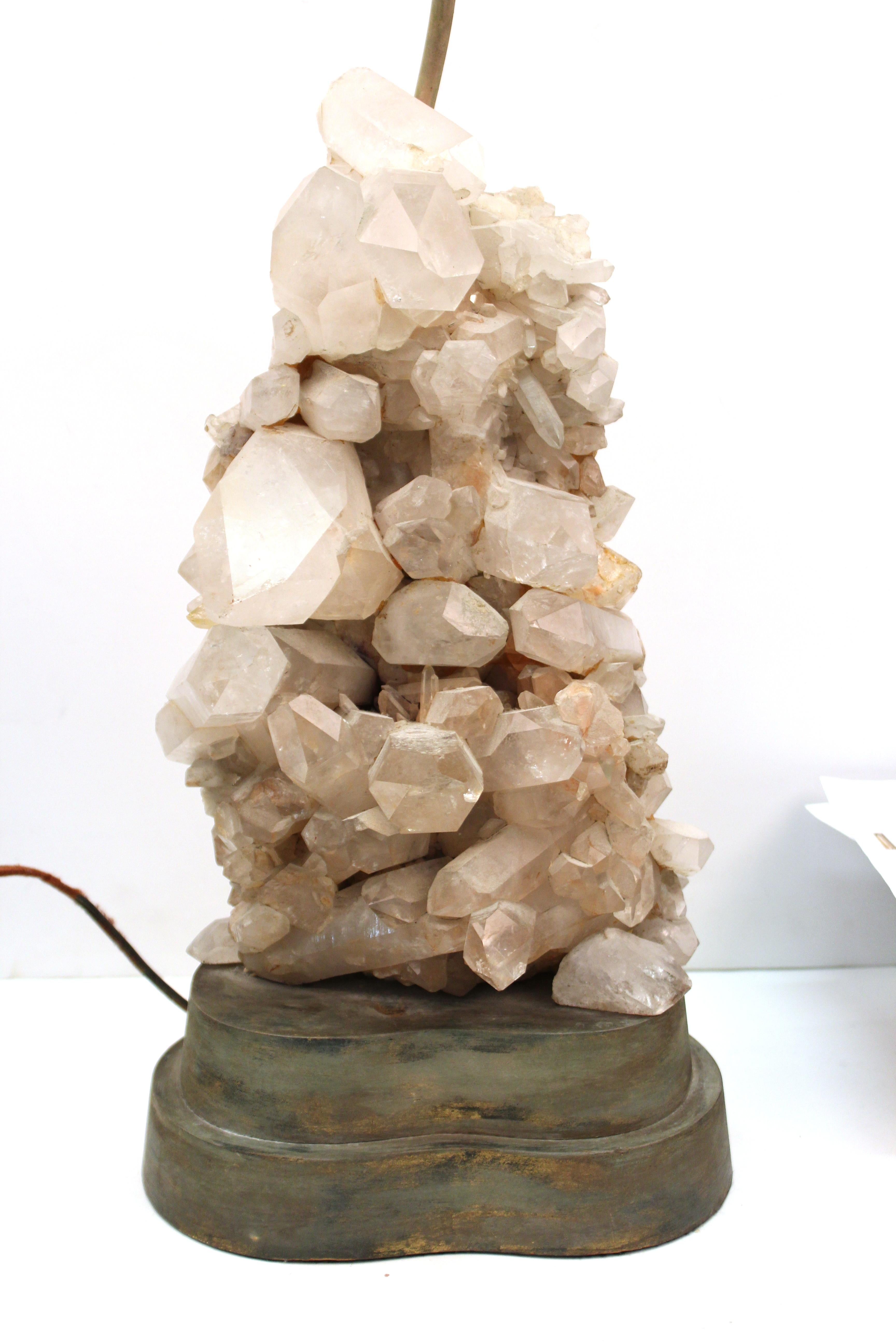 Mid-Century Modern quartz crystal cluster table lamp designed by Carole Stupell. The piece has a large cluster of quartz crystals atop a kidney-shaped wooden base. Made in circa 1950, the piece is in great vintage condition with age-appropriate wear