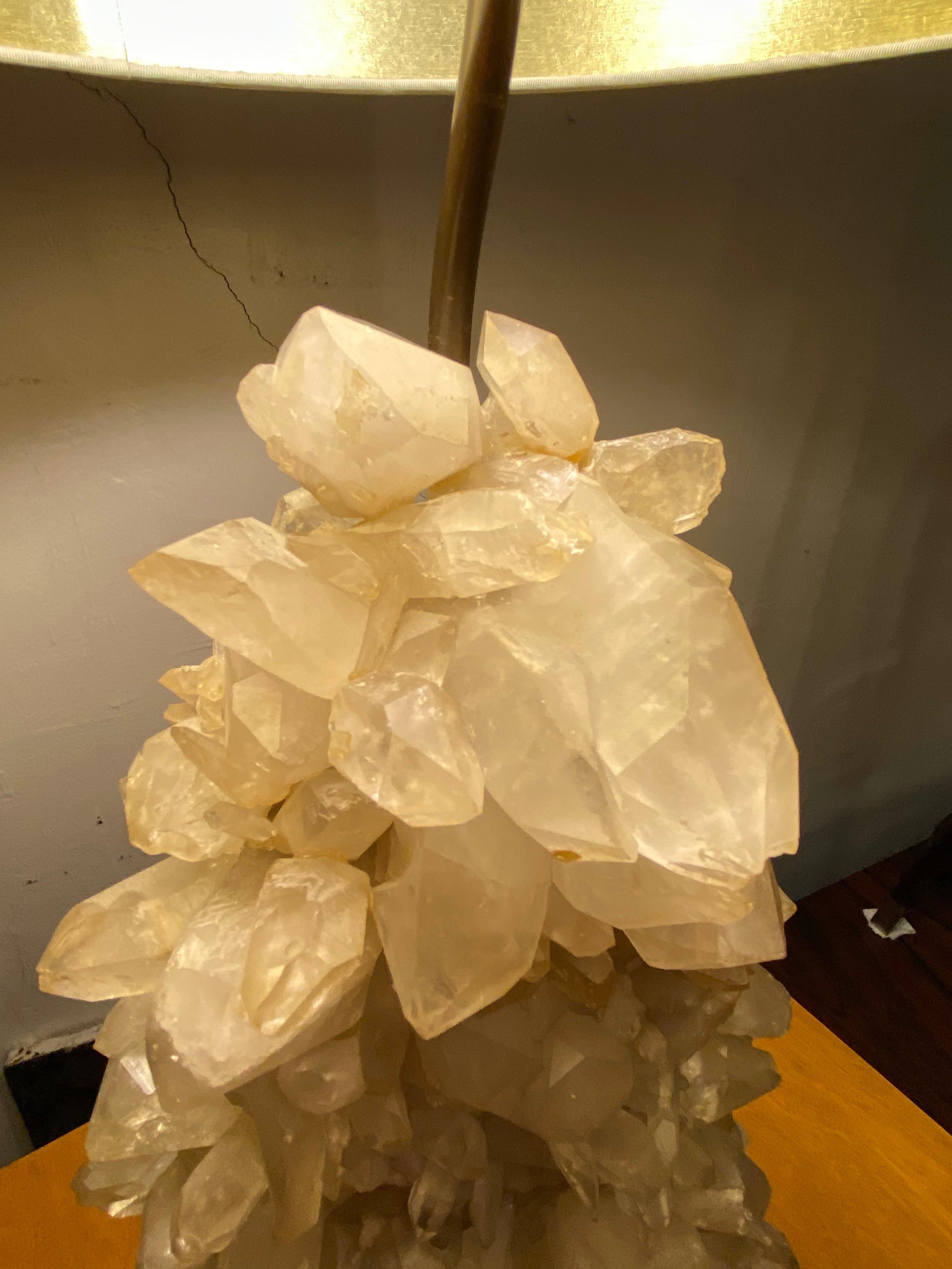 Carole Stupell Quartz crystal cluster table lamp. 1950s lamp made up of rock crystals, attached to a painted wood base. Two Sockets with pull chains. Unique Design that looks amazing lit up! Crystal base is 5