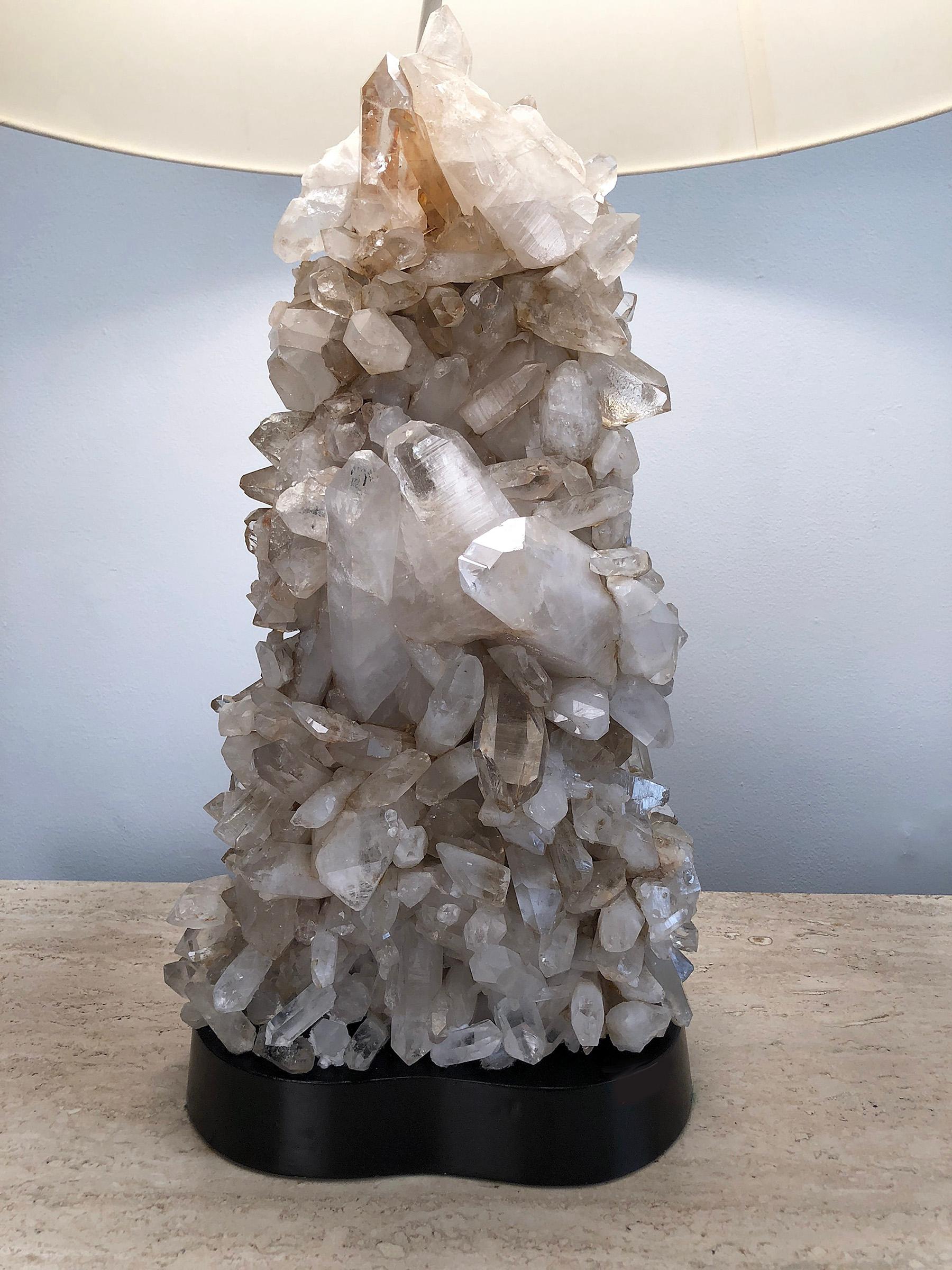 Handcrafted quartz crystal table lamp by Carole Stupell. Base is lacquered wood. Retains original quartz crystal finial. 
Used silk shade measures 23.5