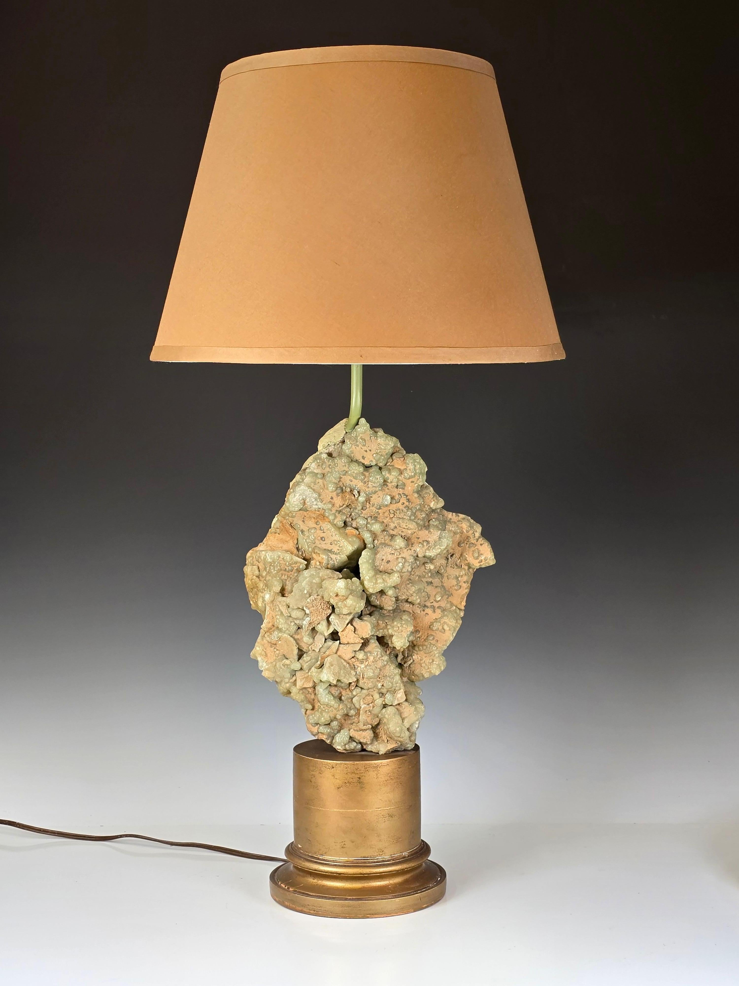 Stunning late 1940s early 1950s rock crystal specimen lamp by Carole Stupell.   Unusual green botryoidal crystals with a hand finished back made to look like chiseled rock.  The crystal i believe is a very large botryoidal Prehinite specimen.   