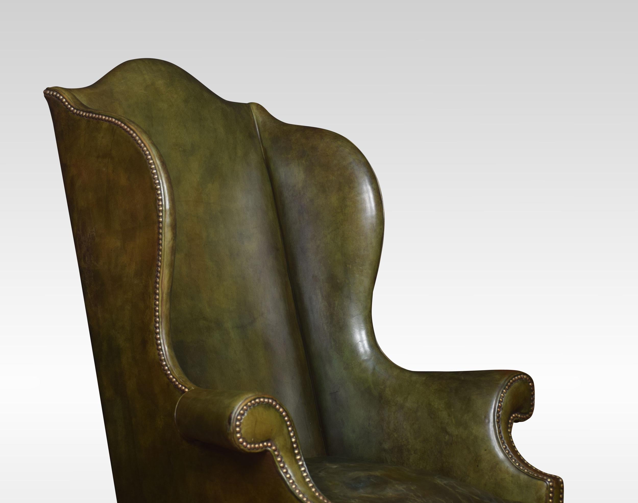 Walnut framed armchair the high arched back above winging out swept scroll arms and removable green leather seat. Raised up on carved legs joined by an arched and carved front stretcher and finely detailed “Braganza” feet.

Dimensions
Height 50