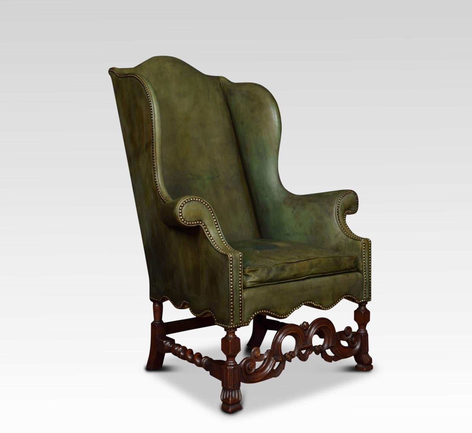 Walnut framed high back armchair was designed and created in the Carolean style of the third quarter of the 17th century, it has a high arched back above the two wings, out swept scroll arms, turned legs and barley twist stretchers, joined by an