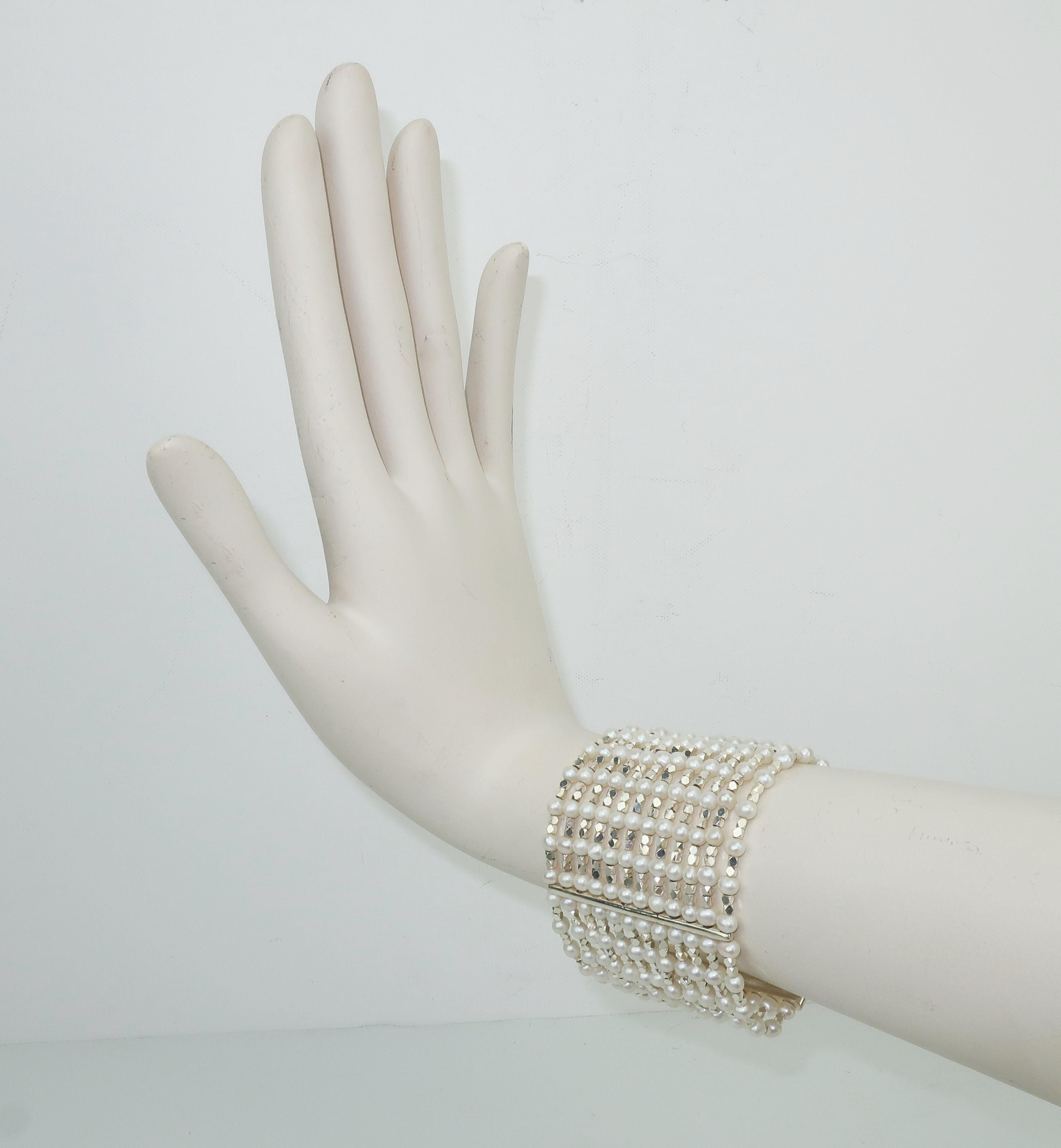 Carolee has been a trendsetting costume jewelry company since the 1970’s.  This 1980's multi strand bracelet has an opulent aesthetic with twelve rows of faceted sterling silver beads interspersed with faux pearls suspended by sterling silver