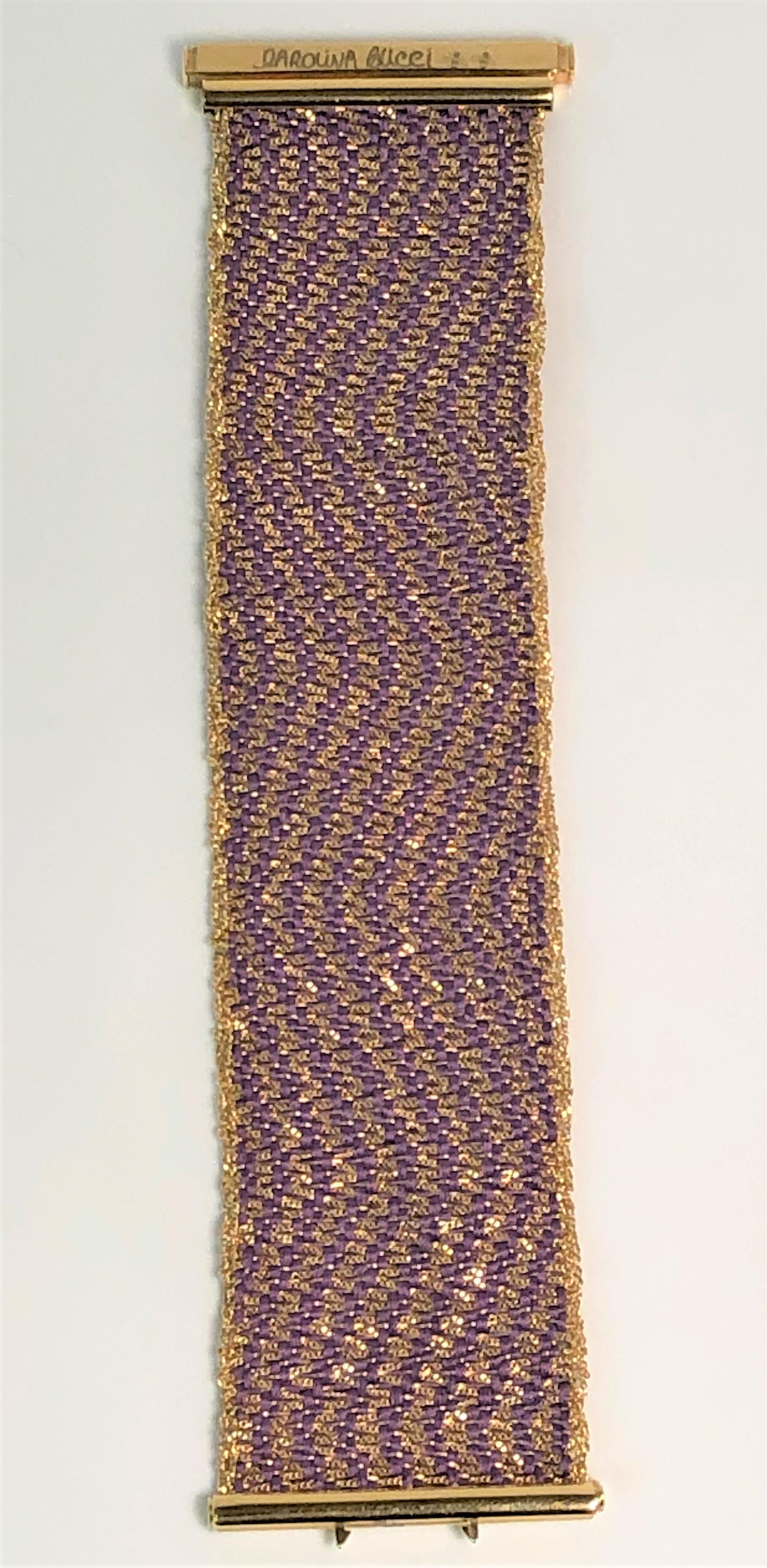 From designer Carolina Bucci, her design style really shows in this beautiful bracelet.
This has never been worn, and you can't find it any more!
18 karat yellow gold woven with purple silk strands in a wavy chevron pattern. 
Bracelet has a