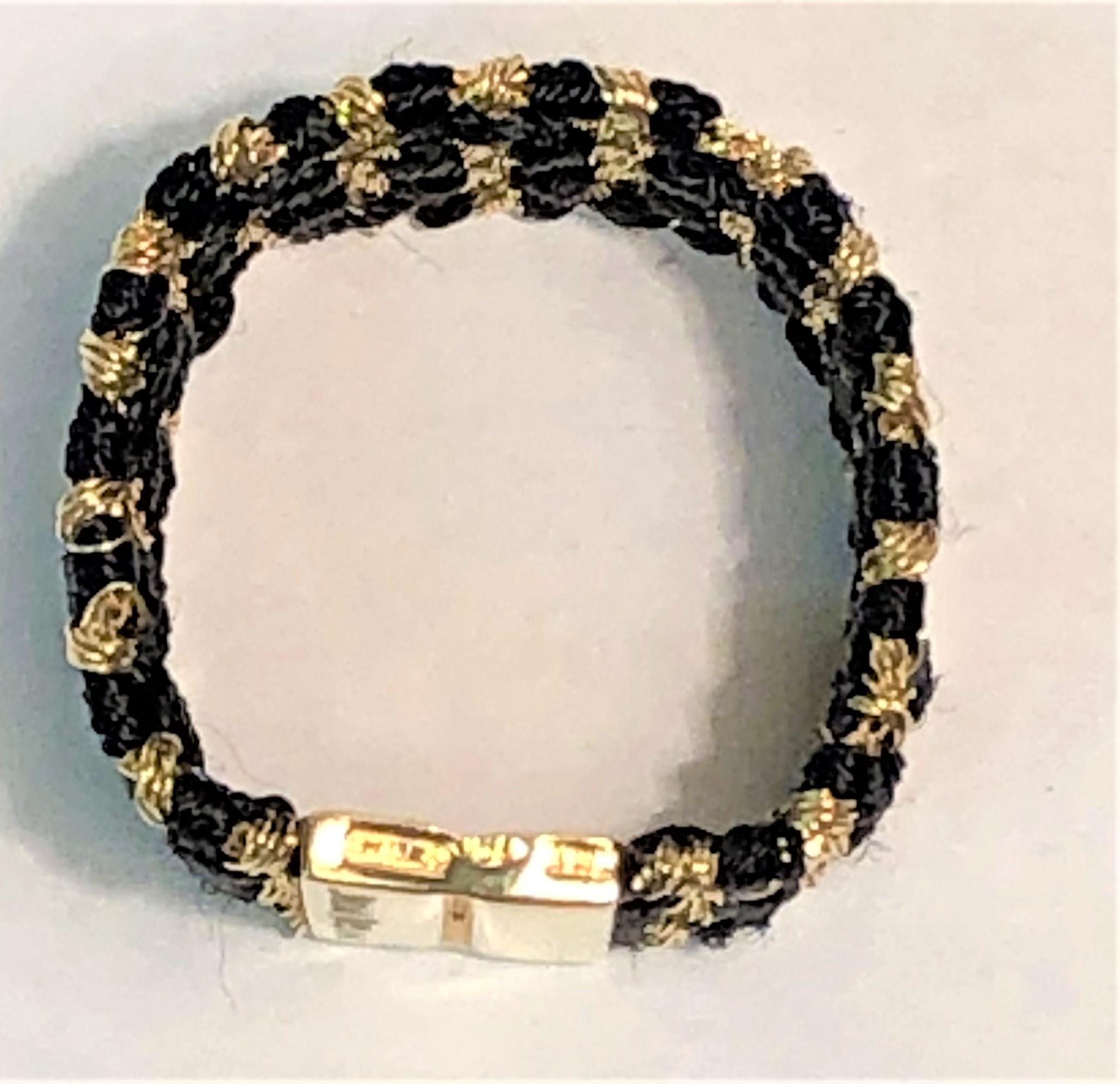 From designer Carolina Bucci, her design style really shows in this beautiful ring.
Black silk strands woven with 18 karat yellow gold strands.
Bottom of ring has a solid 18 karat yellow gold accent with Carolina Bucci's signature and 