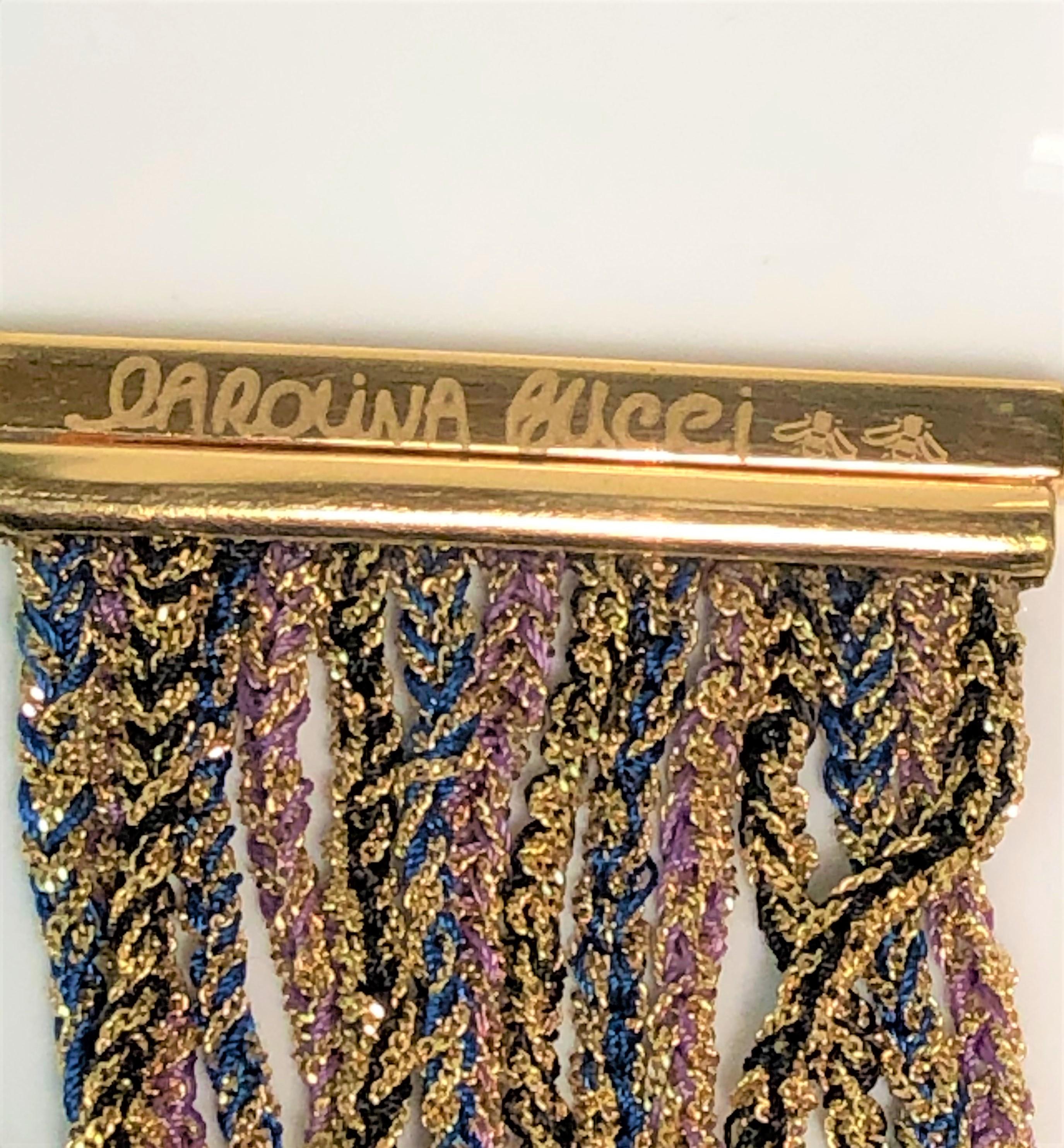 From designer Carolina Bucci, her design style really shows in this beautiful bracelet.
It's an older style but this one has never been worn, and you can't find it anymore!
18 karat yellow gold woven with black, purple and blue strands. Wear with