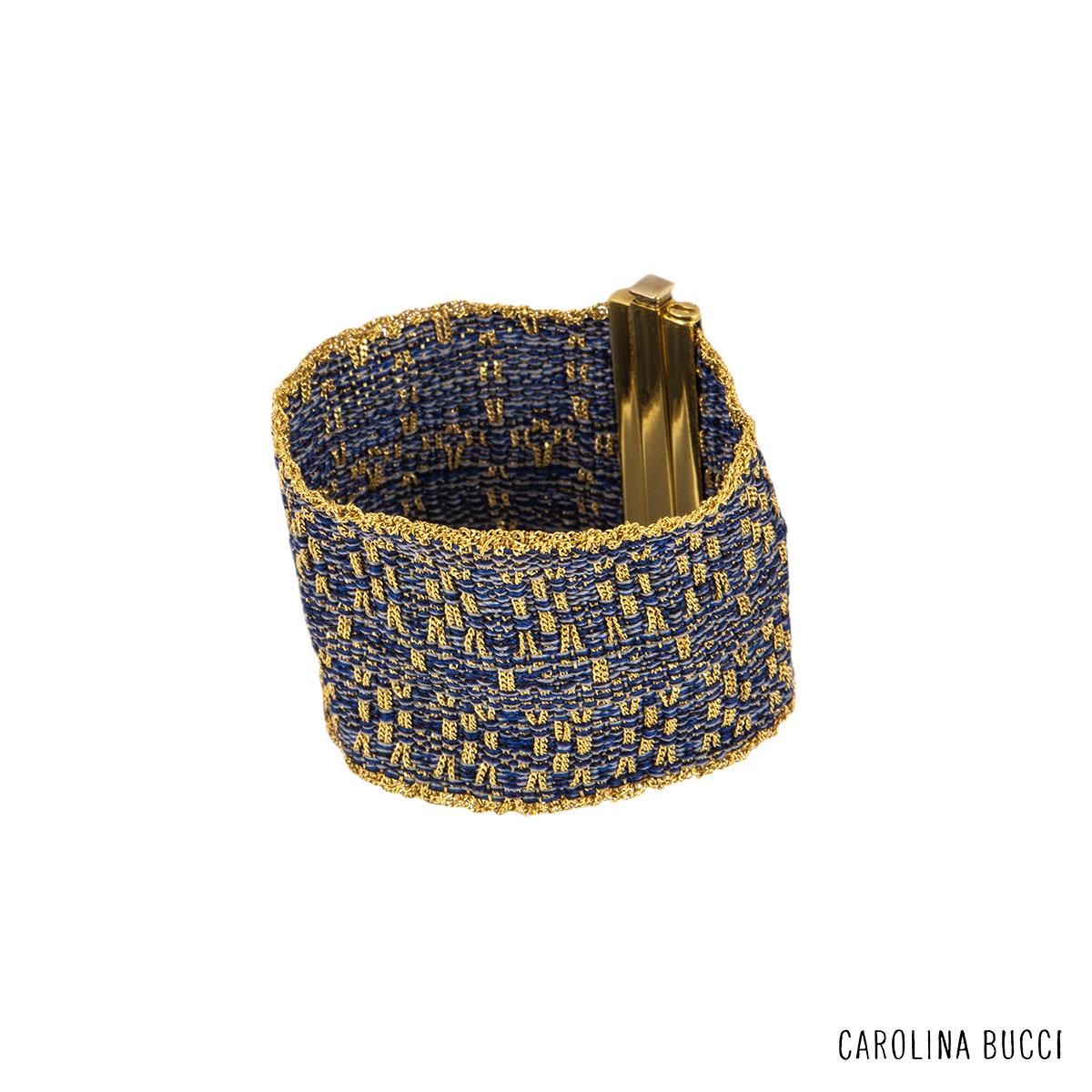 An 18k yellow gold woven mesh bracelet by Carolina Bucci. The bracelet is set with yellow gold chain and silk thread intertwined which each other in a patterned design. The bracelet features a push down bar clasp with a length of 6 inches with a