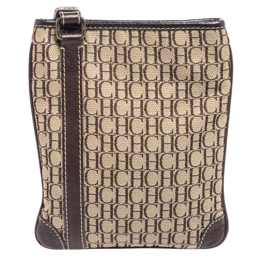This sling bag from the House of Carolina Herrera is a great buy that will make you look classy and stylish! It is crafted using beige-brown Monogram canvas on the exterior. It comes with brass-toned hardware, leather trims, and a fabric-lined