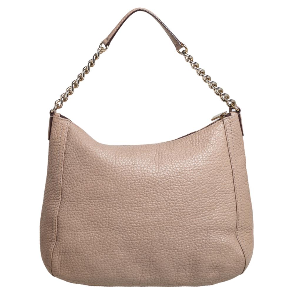 Designed from beige leather, this Carolina Herrera hobo will go well with your everyday style. It has a zip-enclosed fabric interior, a tassel charm, and a single chain-leather handle.