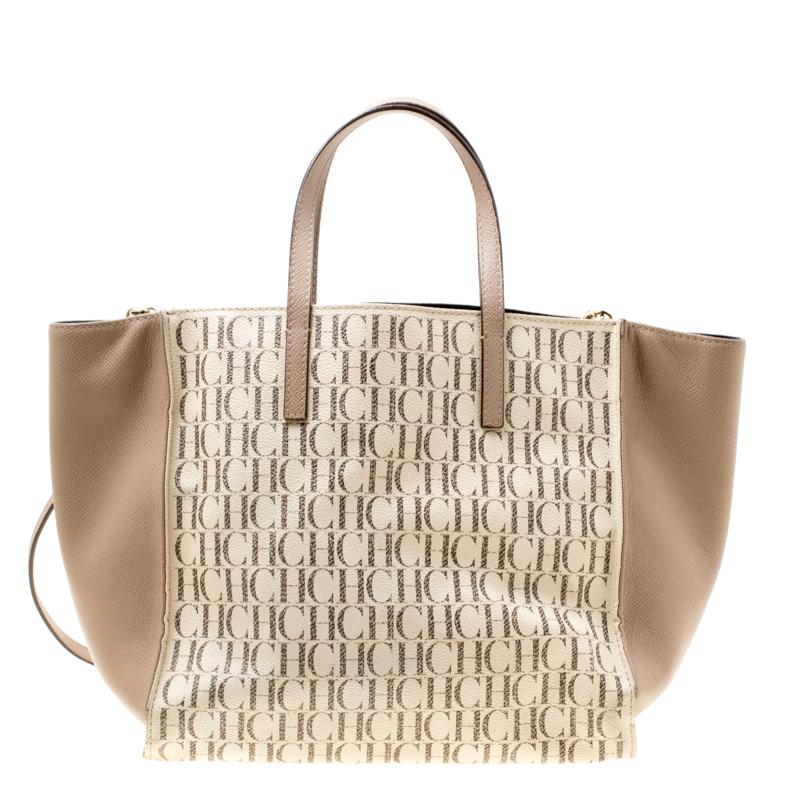 This Carolina Herrera tote is all that you need to instantly lift up your look. Crafted from Monogram canvas in a beige/off white hue it is styled with leather trims. It has a well-sized fabric interior, and the bag features two top handles, a