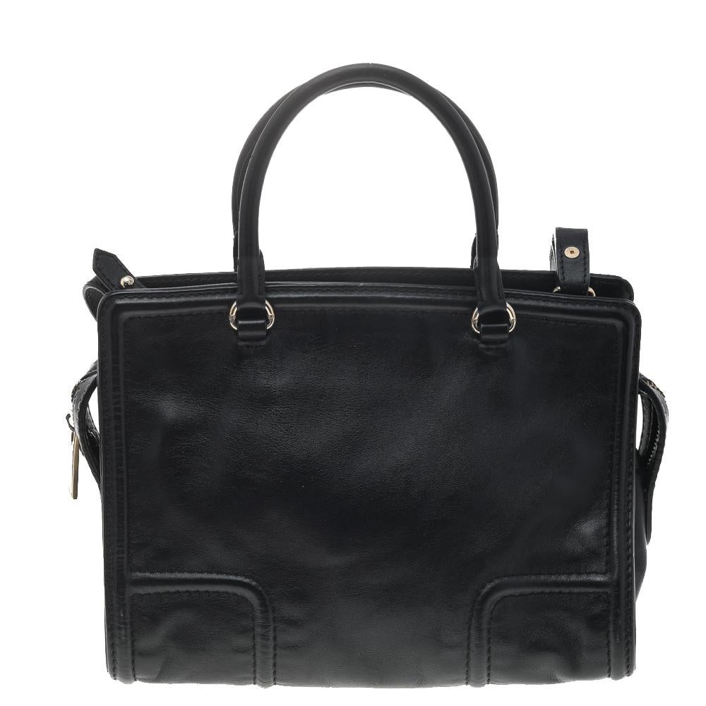 This CHCH logo tote from Carolina Herrera is a must-have for all the fashionistas. With its black shade and structured shape, the leather bag is versatile and will match well with any outfit. Two top handles and a shoulder strap make it an