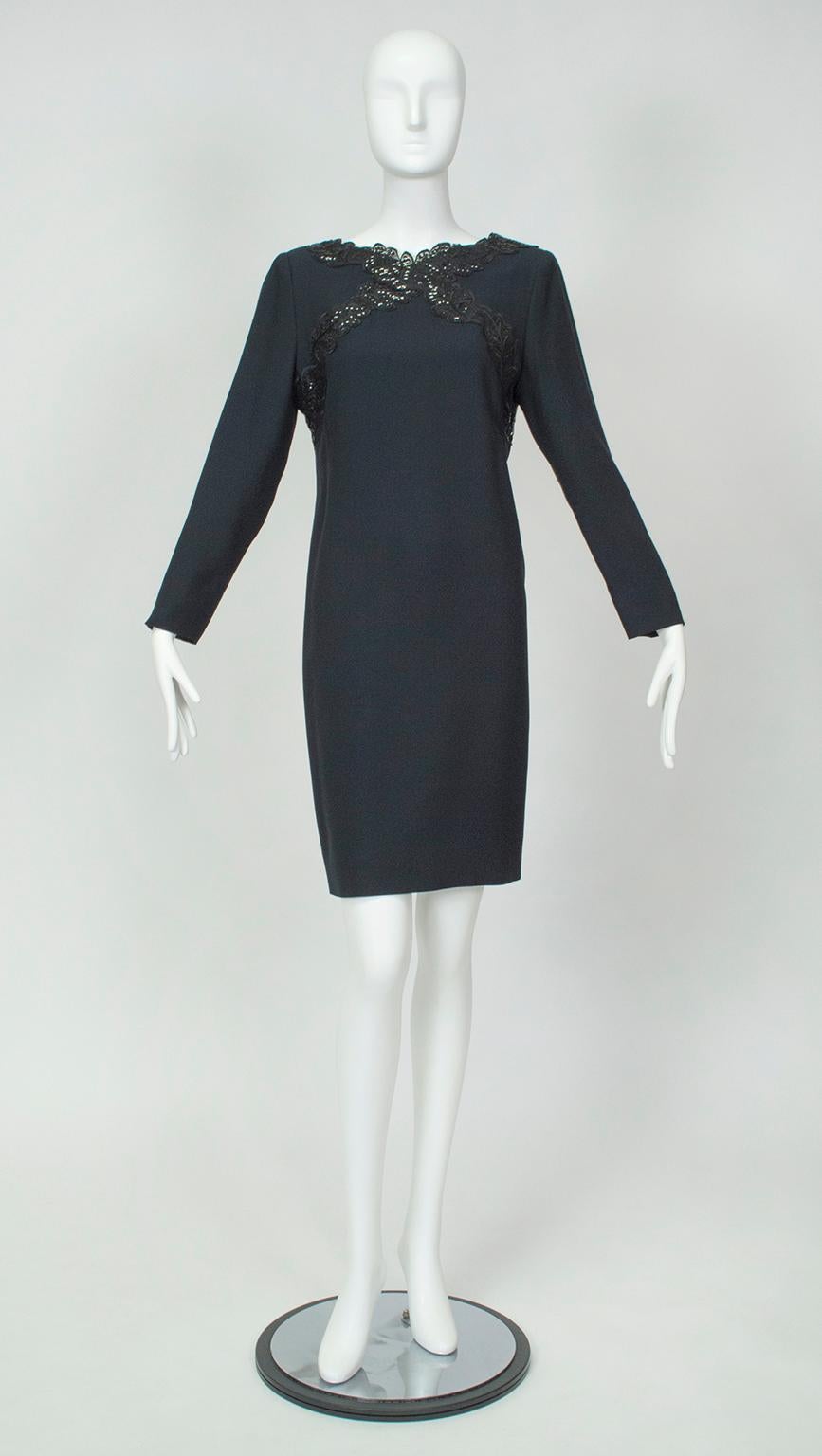An elusive long sleeved cocktail dress for the lady who wishes to cover her arms but accentuate her legs. This abbreviated—almost mini—shift bridges the gap between covered and uncovered thanks to its short hemline, but balances the attention with
