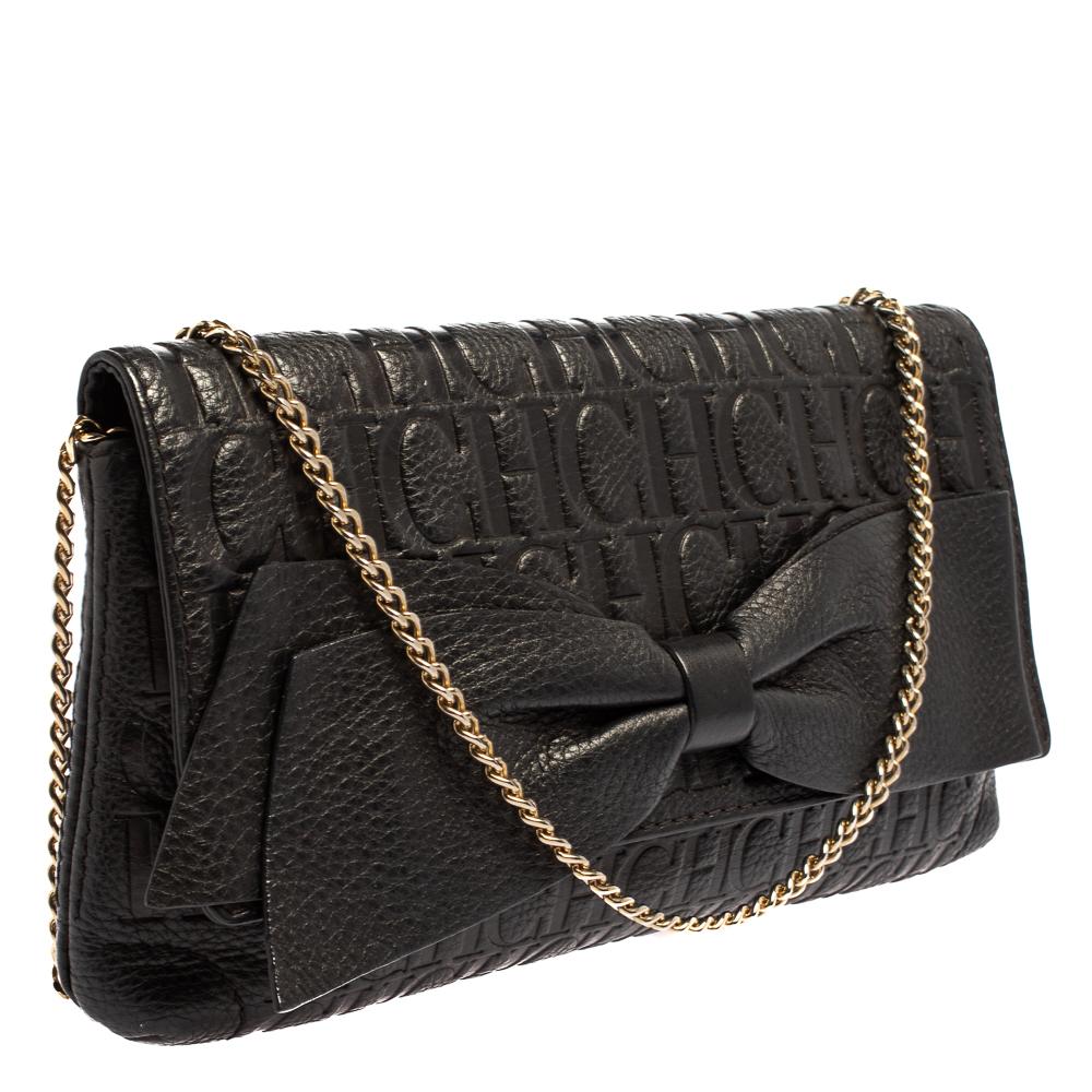 A creation that transforms from a clutch to a shoulder bag as per your liking. The Carolina Herrera clutch is made from monogram leather and detailed with a bow on the font. The clutch is accompanied by a chain that you can tuck inside.

Includes: